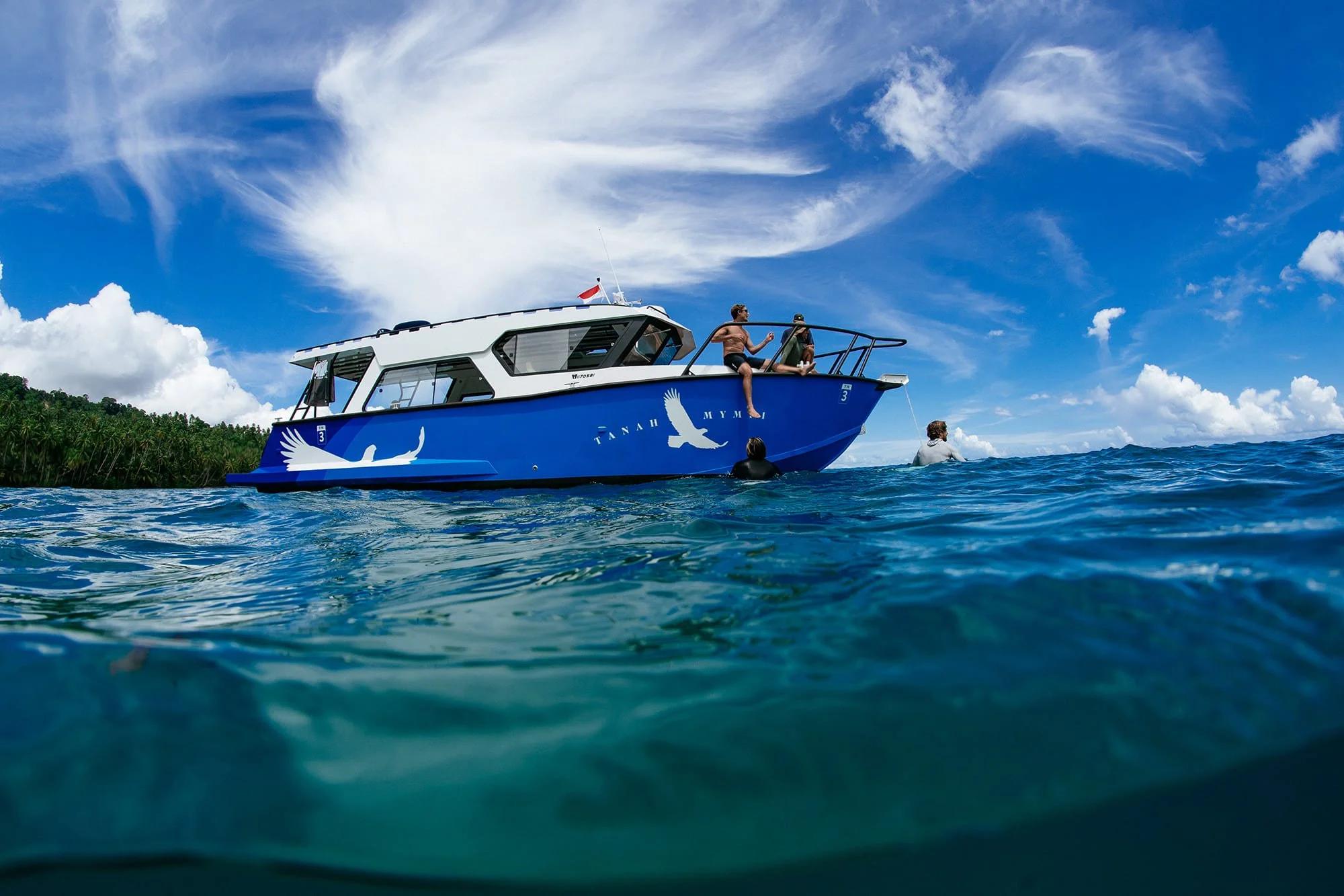 Guests relax on the deck of a boat, Tanah Mympi's fleet
