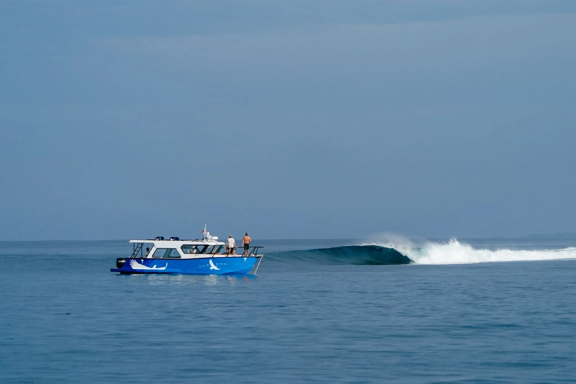 A wave barrels over near Tanah Mympi, its curl catching the light.