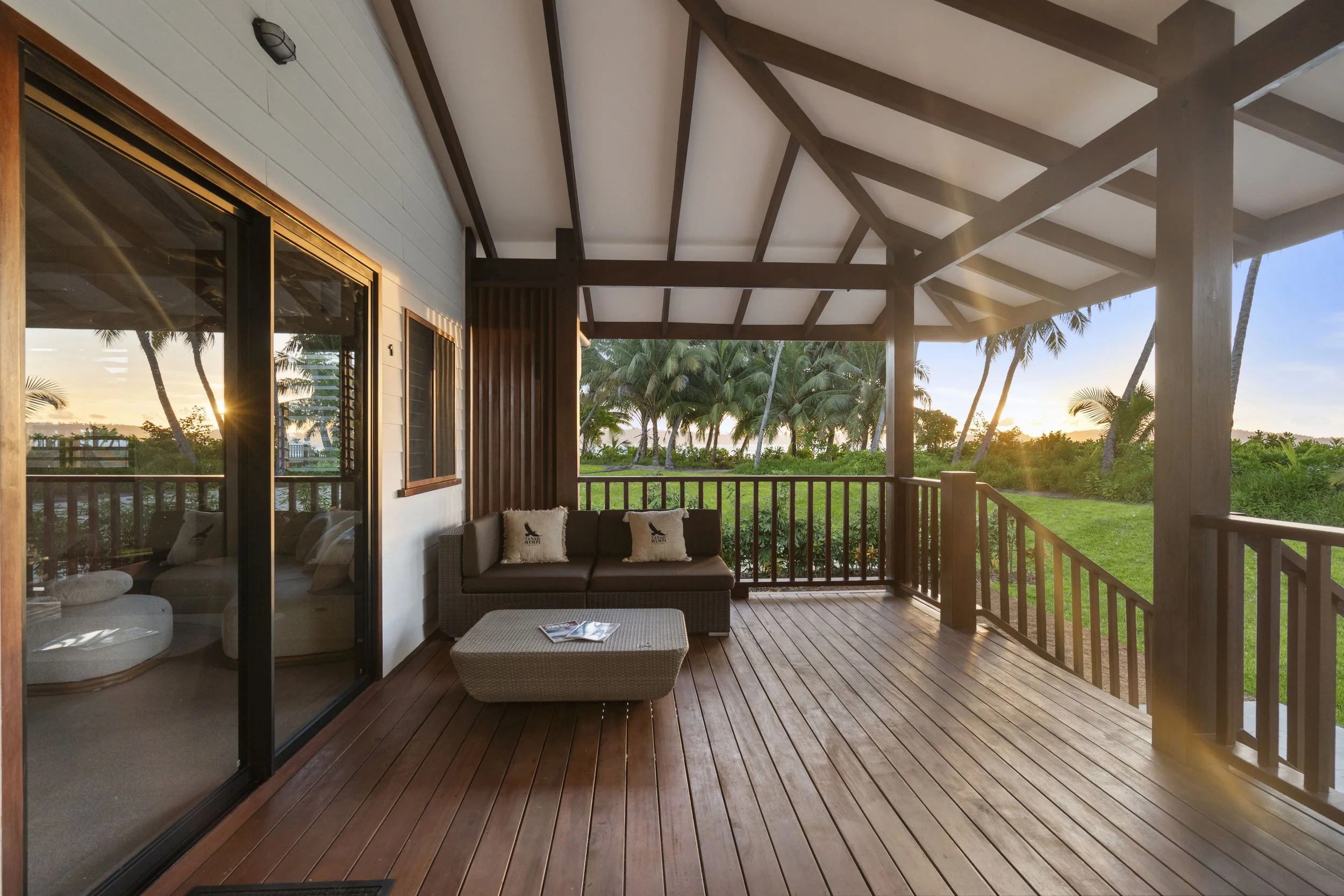 The private deck of an Ocean View suite at Tanah Mympi, overlooking the water.