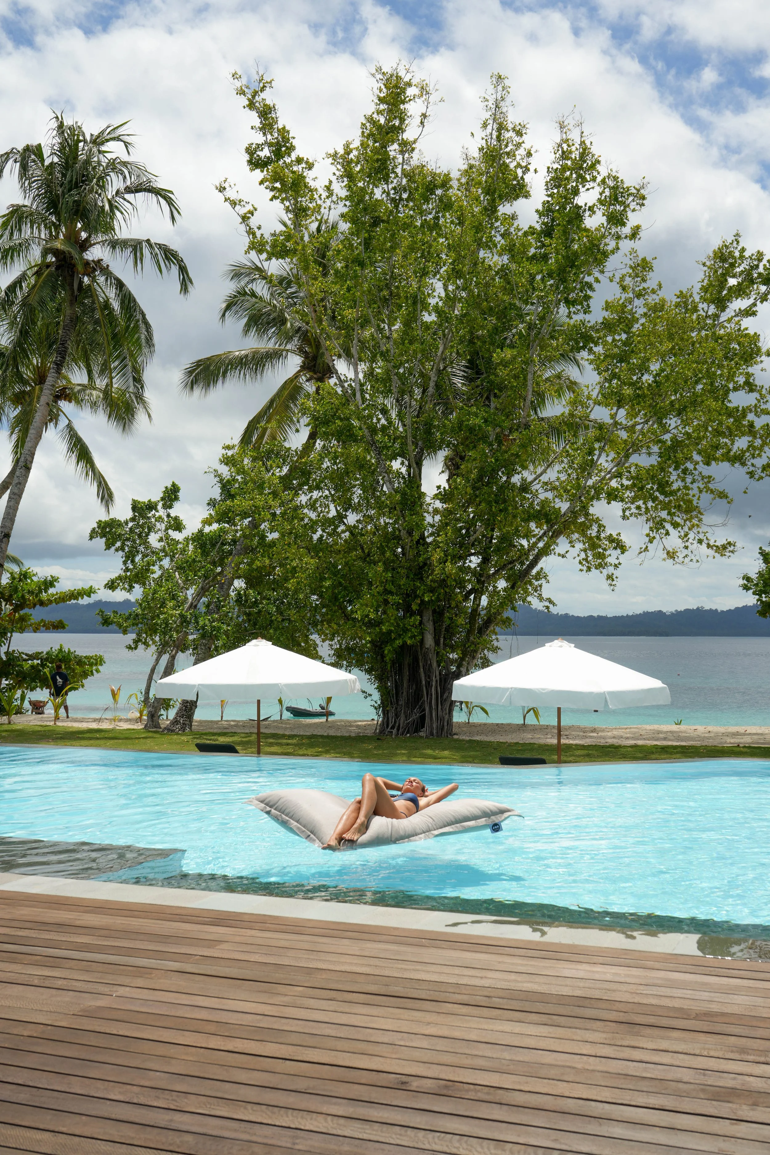 Guests relax at the swim-up bar in Tanah Mympi's pool.