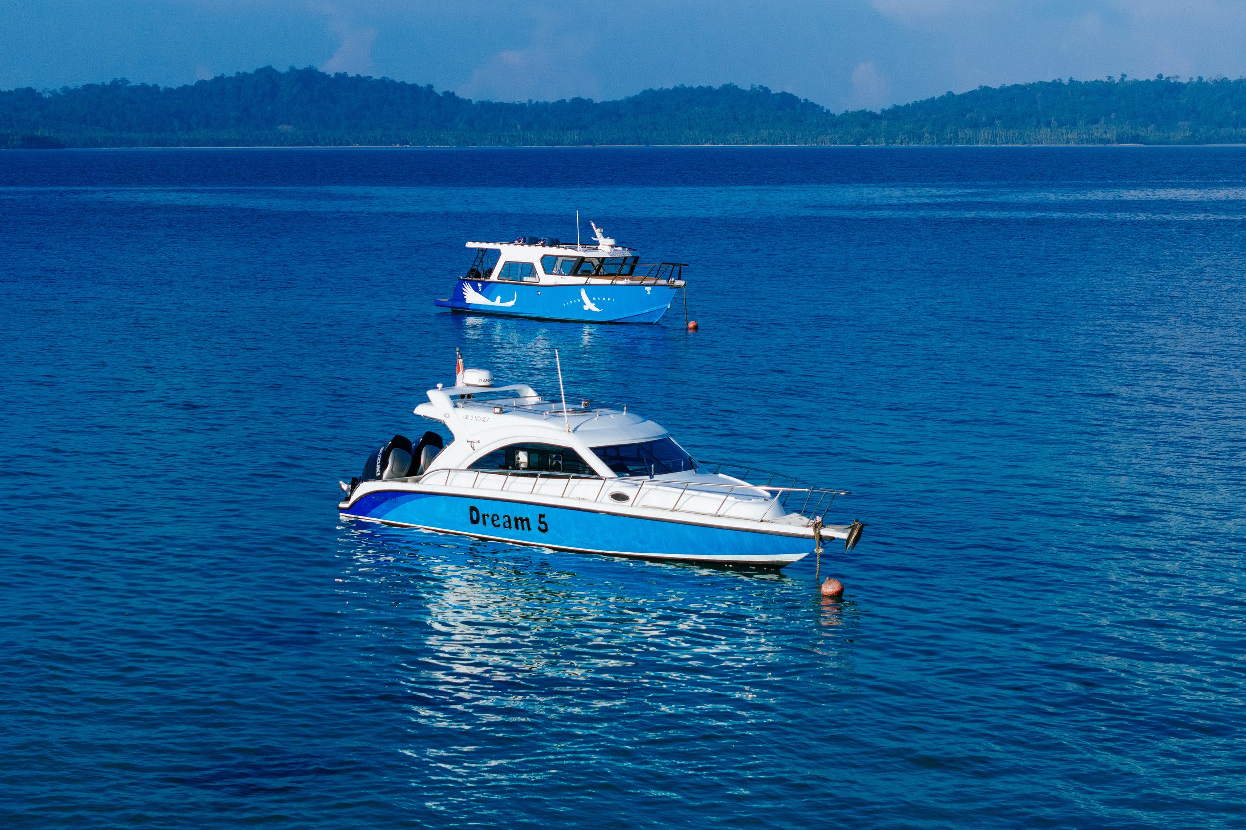 Several of Tanah Mympi's boats anchored together near the island.