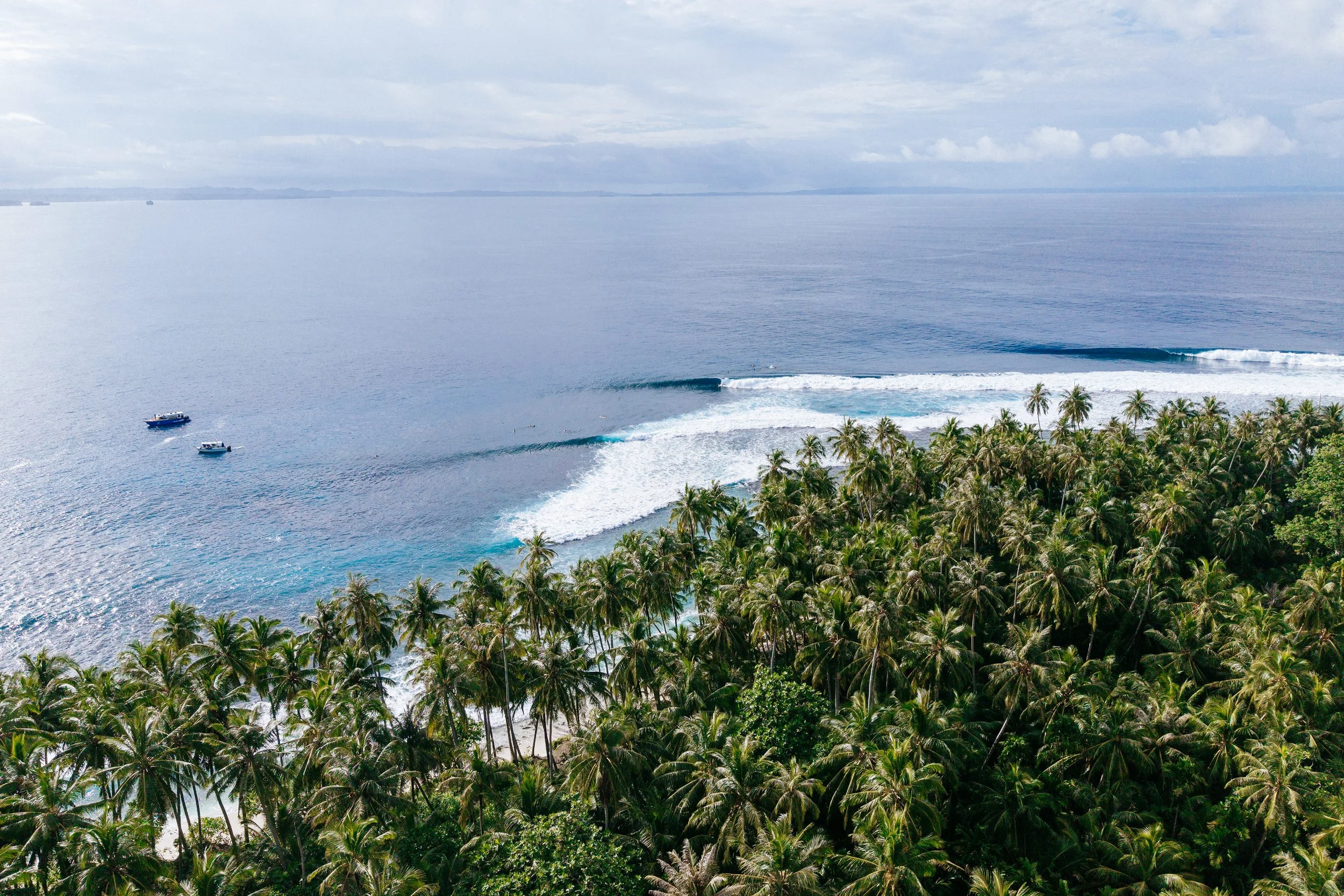 Waves peeling off the shore near Tanah Mympi