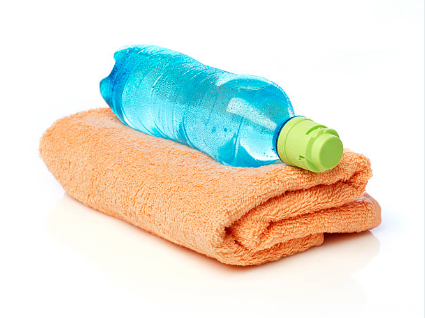 A plastic water bottle placed on a folded orange towel.