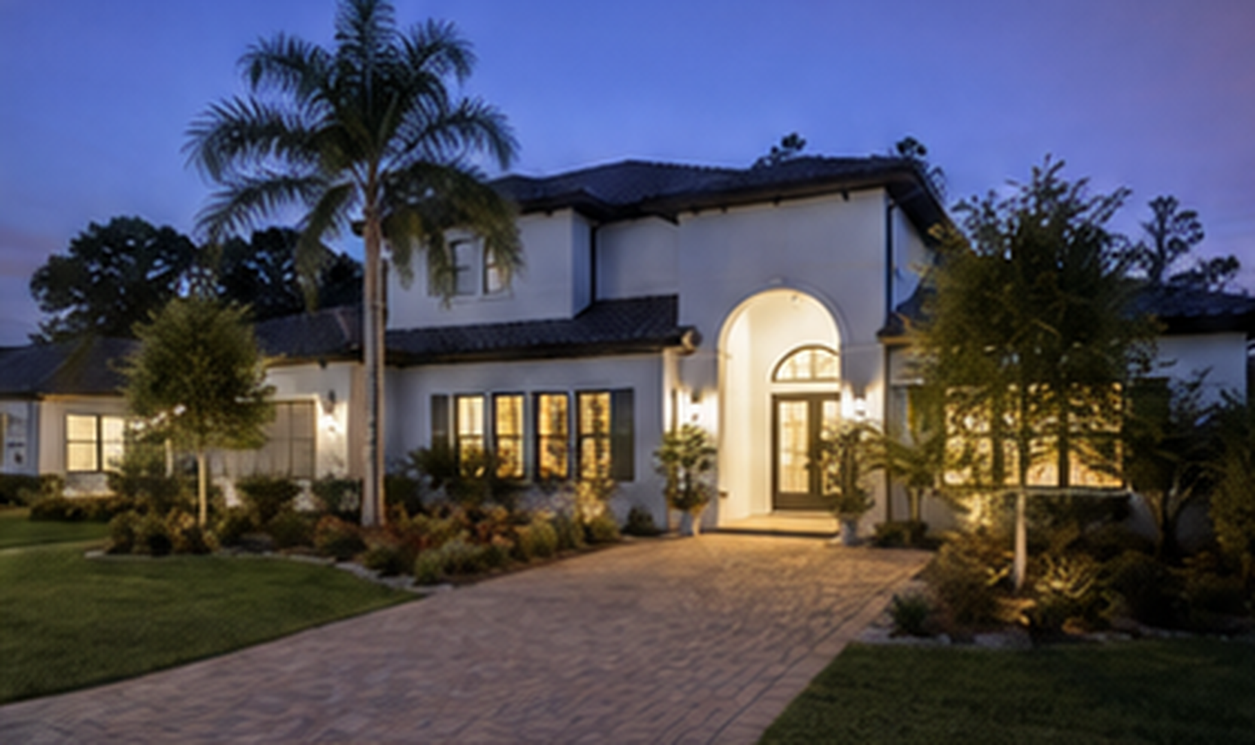 Tampa Bay residential home at dusk with palm trees and landscaped grounds.