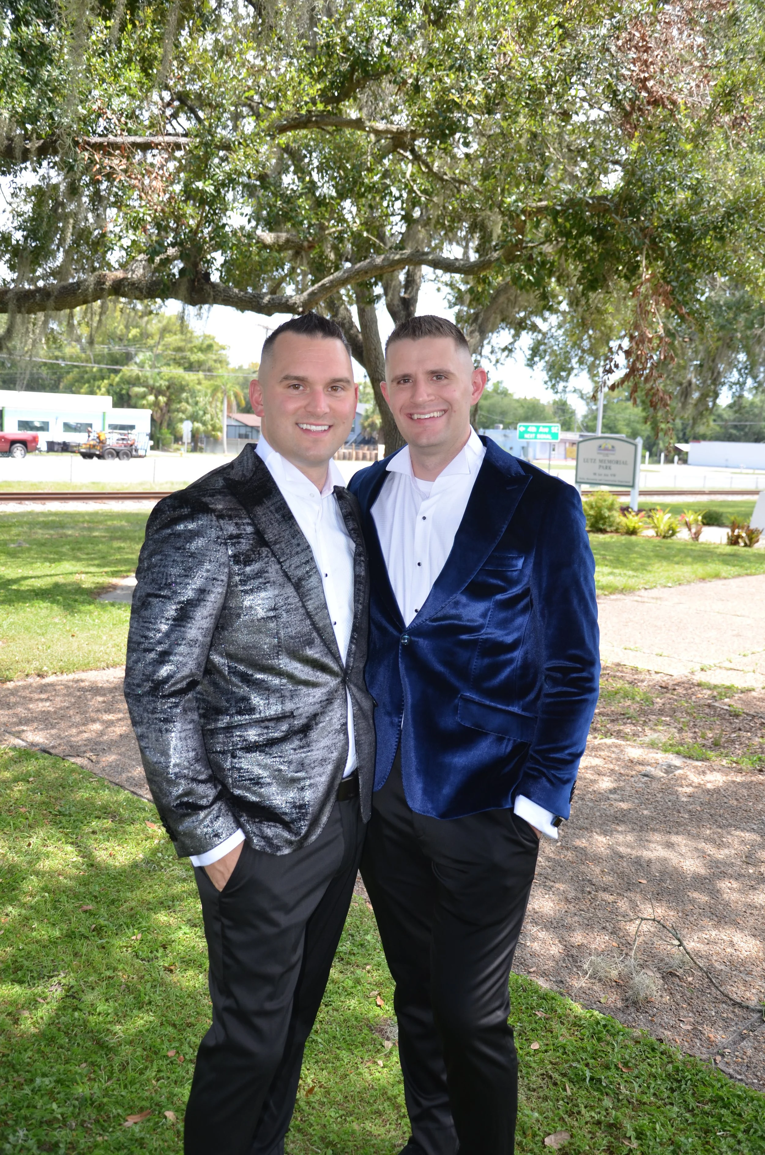 Joshua and Brett Edwards, The Husbands of Tampa Bay, standing together outdoors in formal attire.