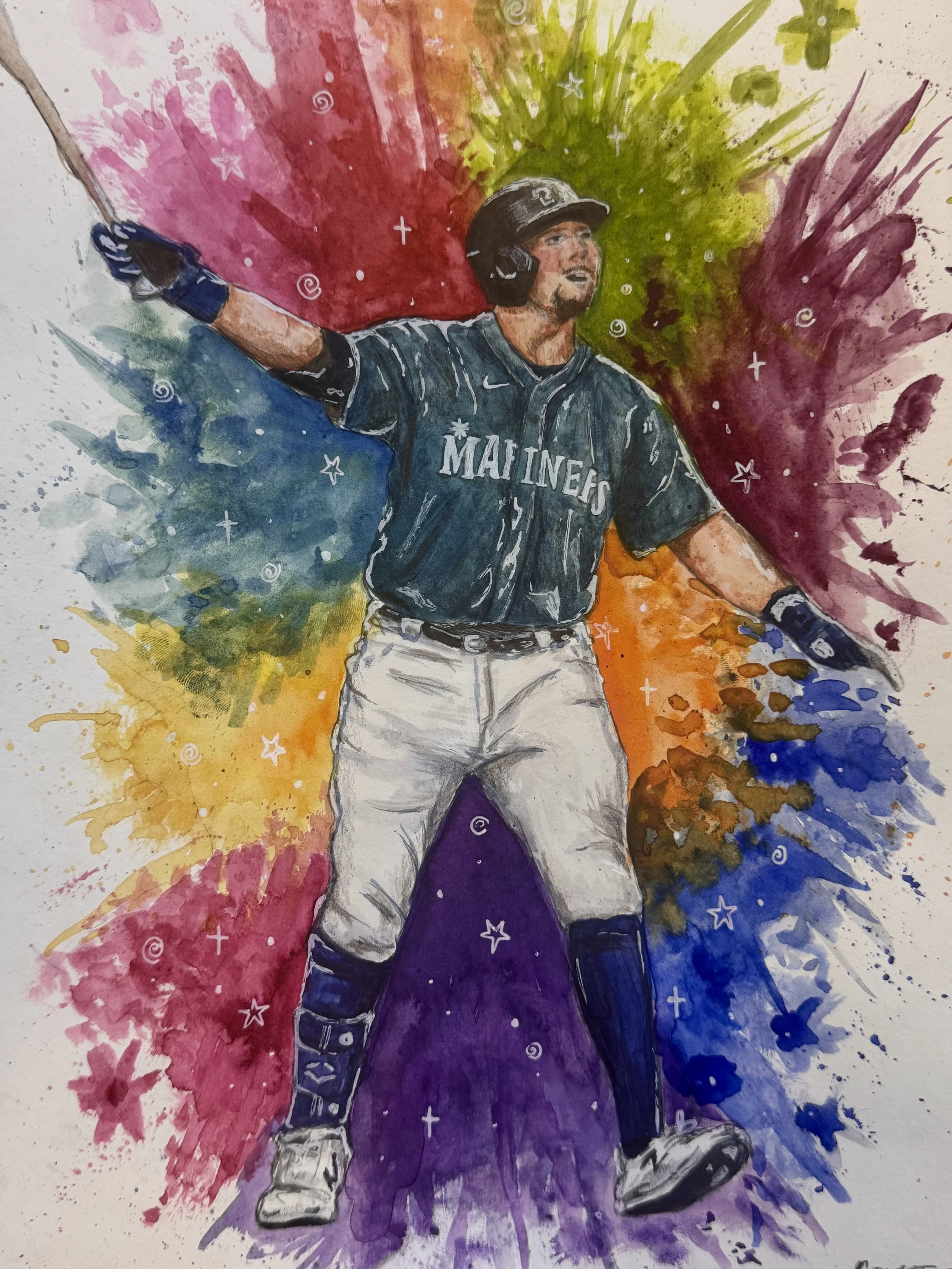 Watercolor painting of a baseball player wearing a Mariners uniform, standing on a purple base, gesturing with one arm outstretched against a colorful abstract background of red, green, yellow, and blue splashes.