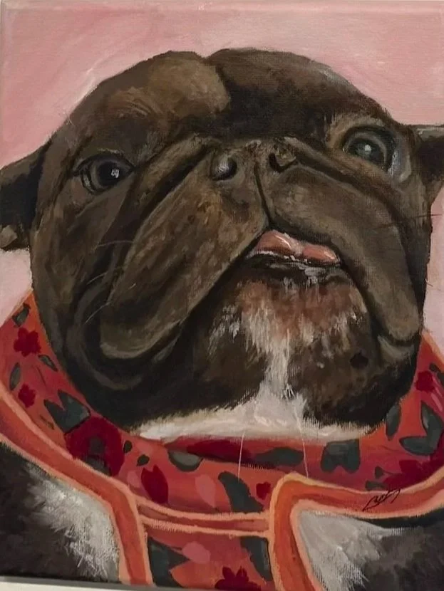 A painting of a French bulldog dog with a wrinkled face, wearing a red and pink collar with black and red heart and floral patterns, against a pink background.