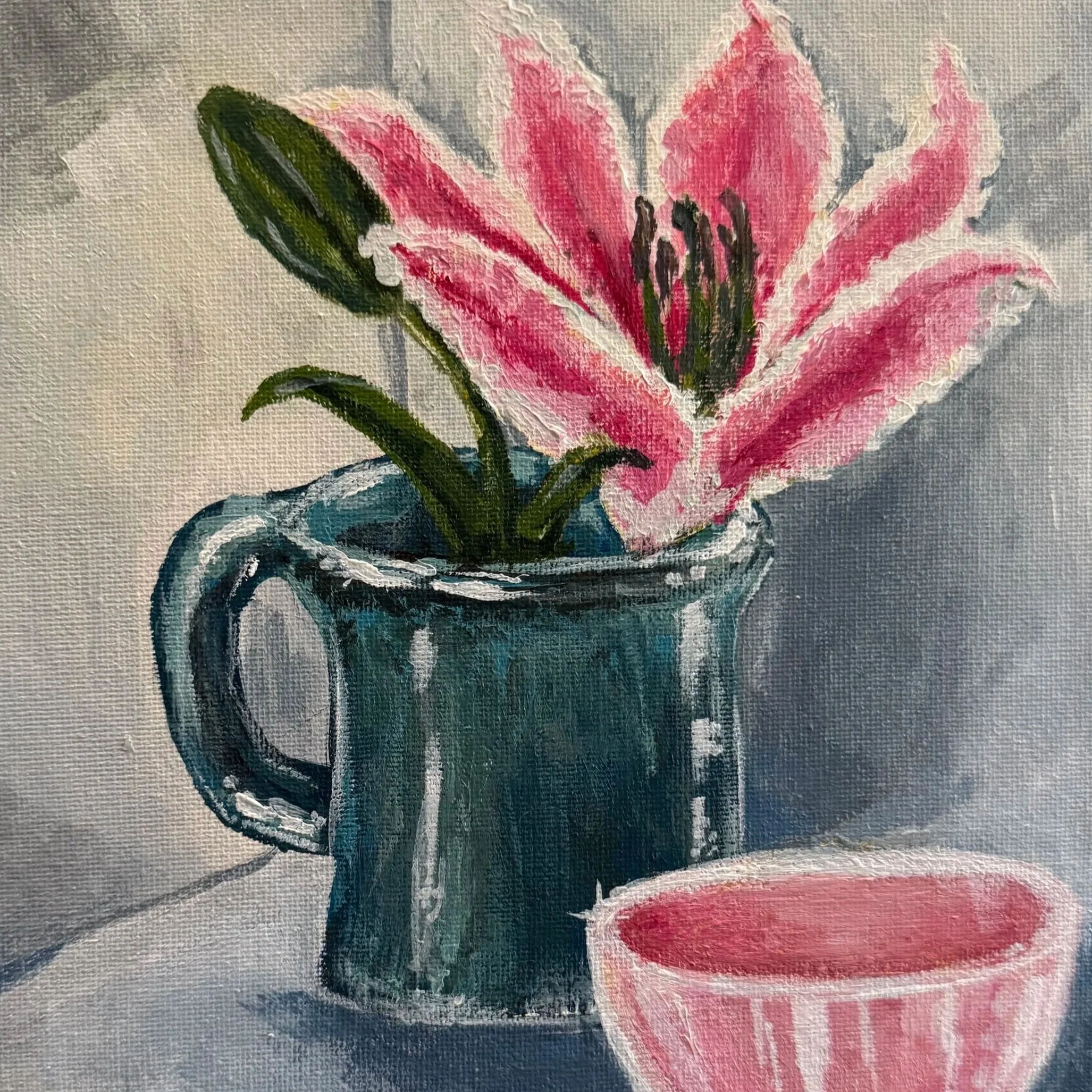 Close-up view of a pink lily flower with green leaves in a black and white patterned pot, painted with visible brushstrokes on canvas.