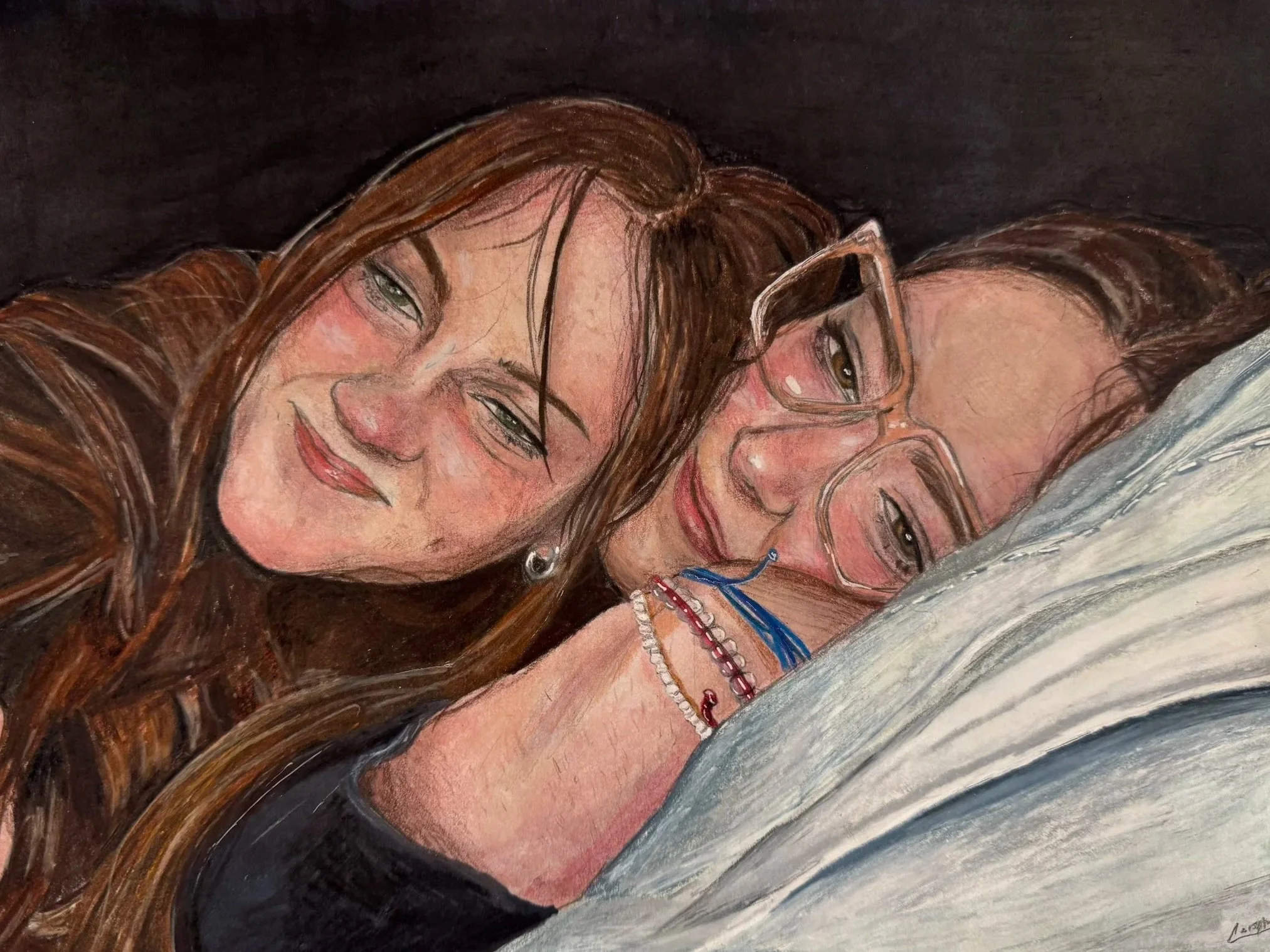 Painting of two women with brown hair smiling, one wearing glasses and multiple necklaces, lying close together.