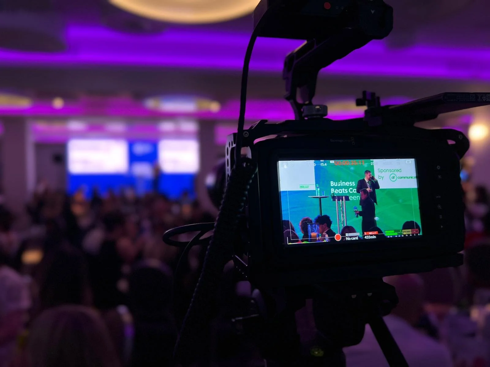 Video camera recording the presenter speaking on stage at Business Beats Cancer Aberdeen.