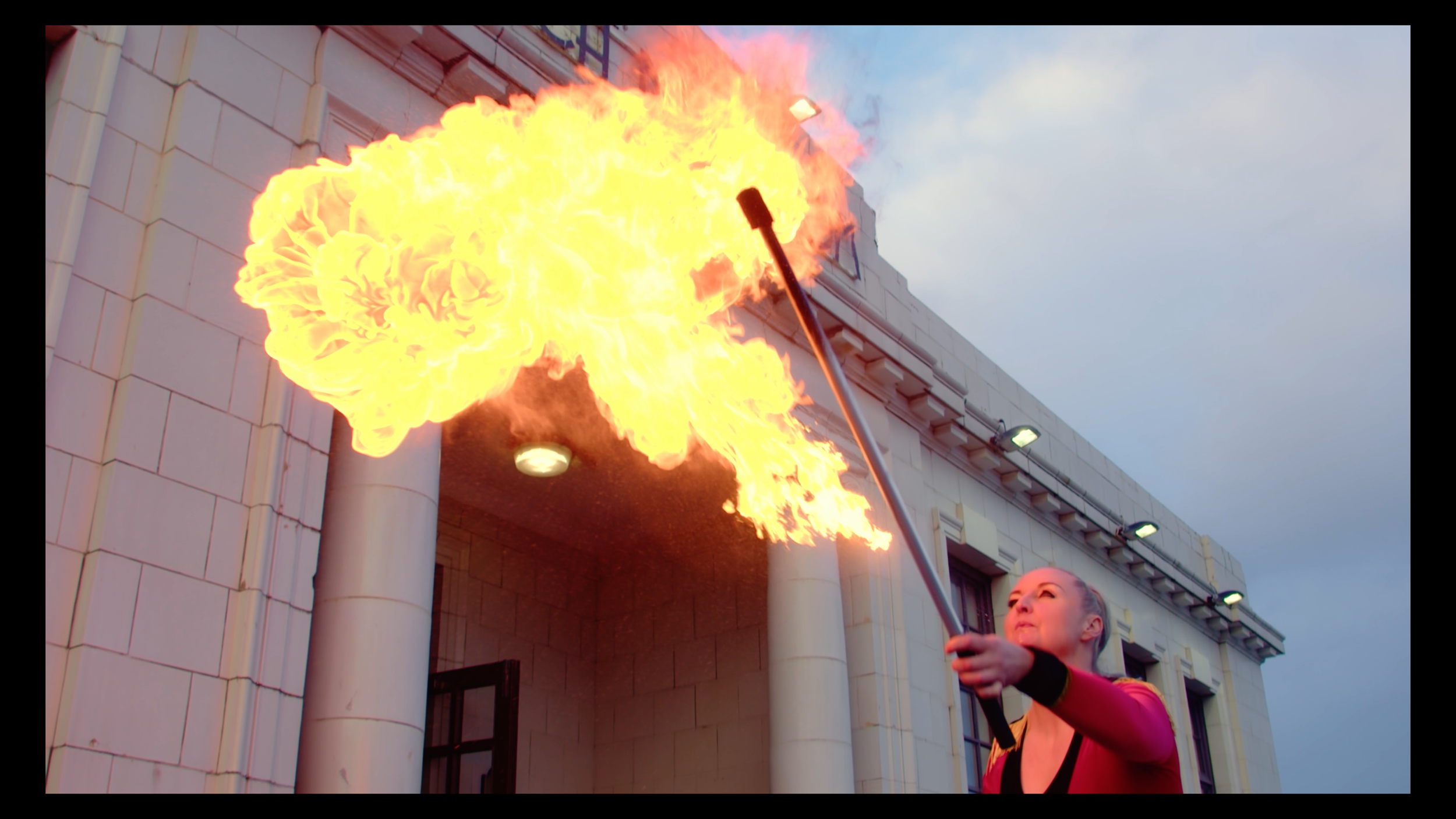 Fire performer breathing a large flame outside the CLAN Cancer Support annual ball.