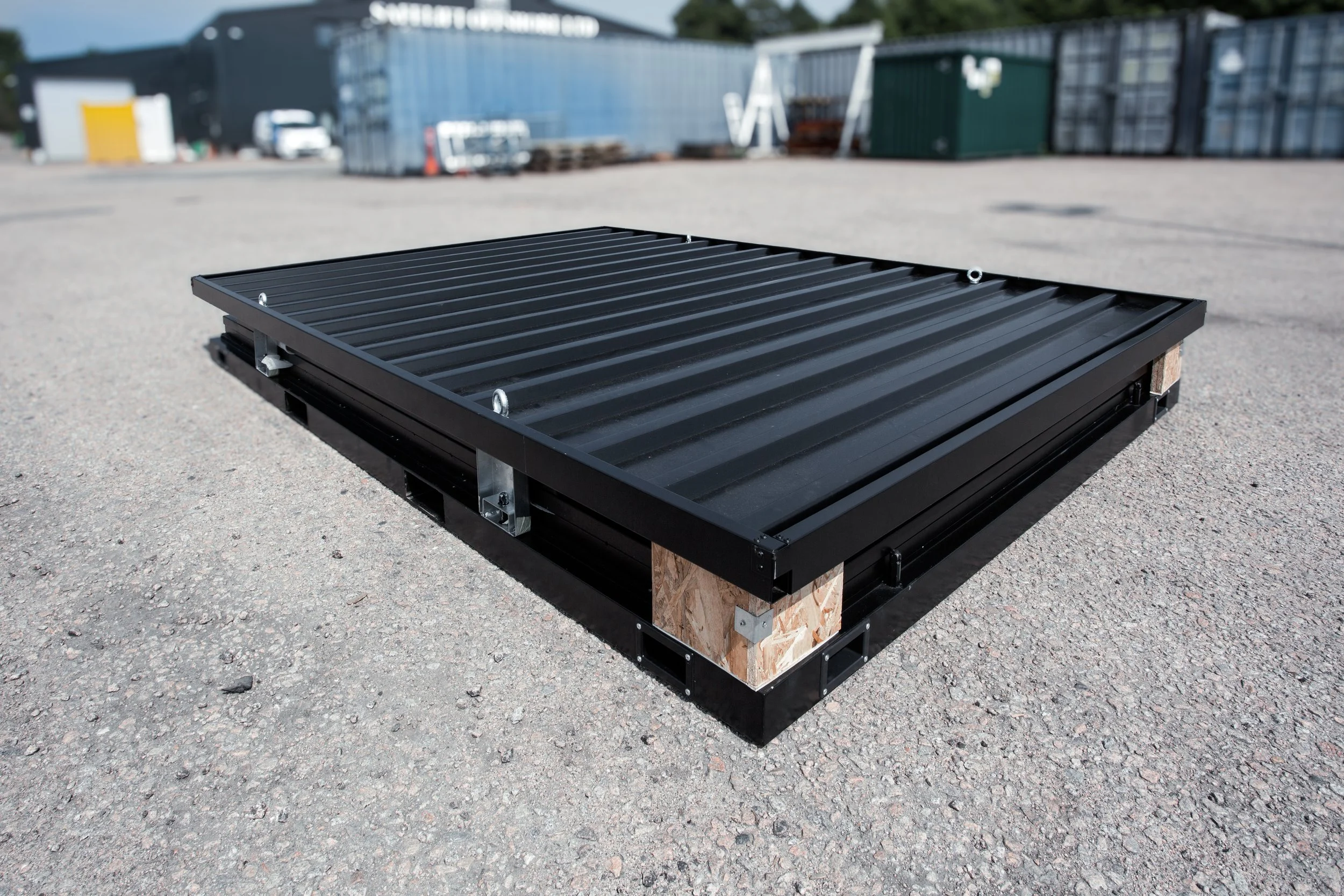 Site Store modular container folded into its compact transport configuration in the yard.