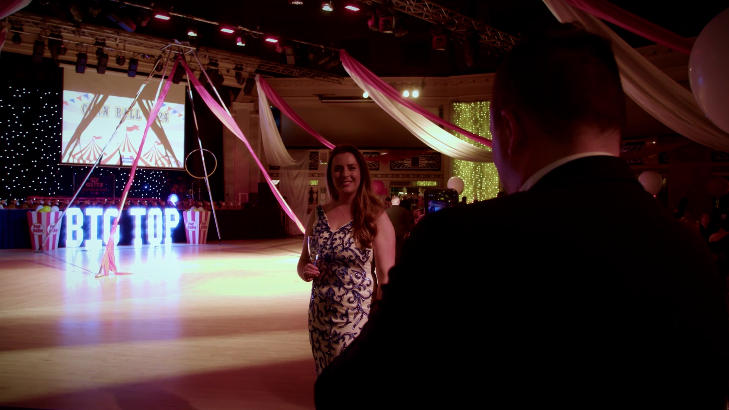 Guests posing for a photograph beside the stage at the CLAN Cancer Support annual ball.