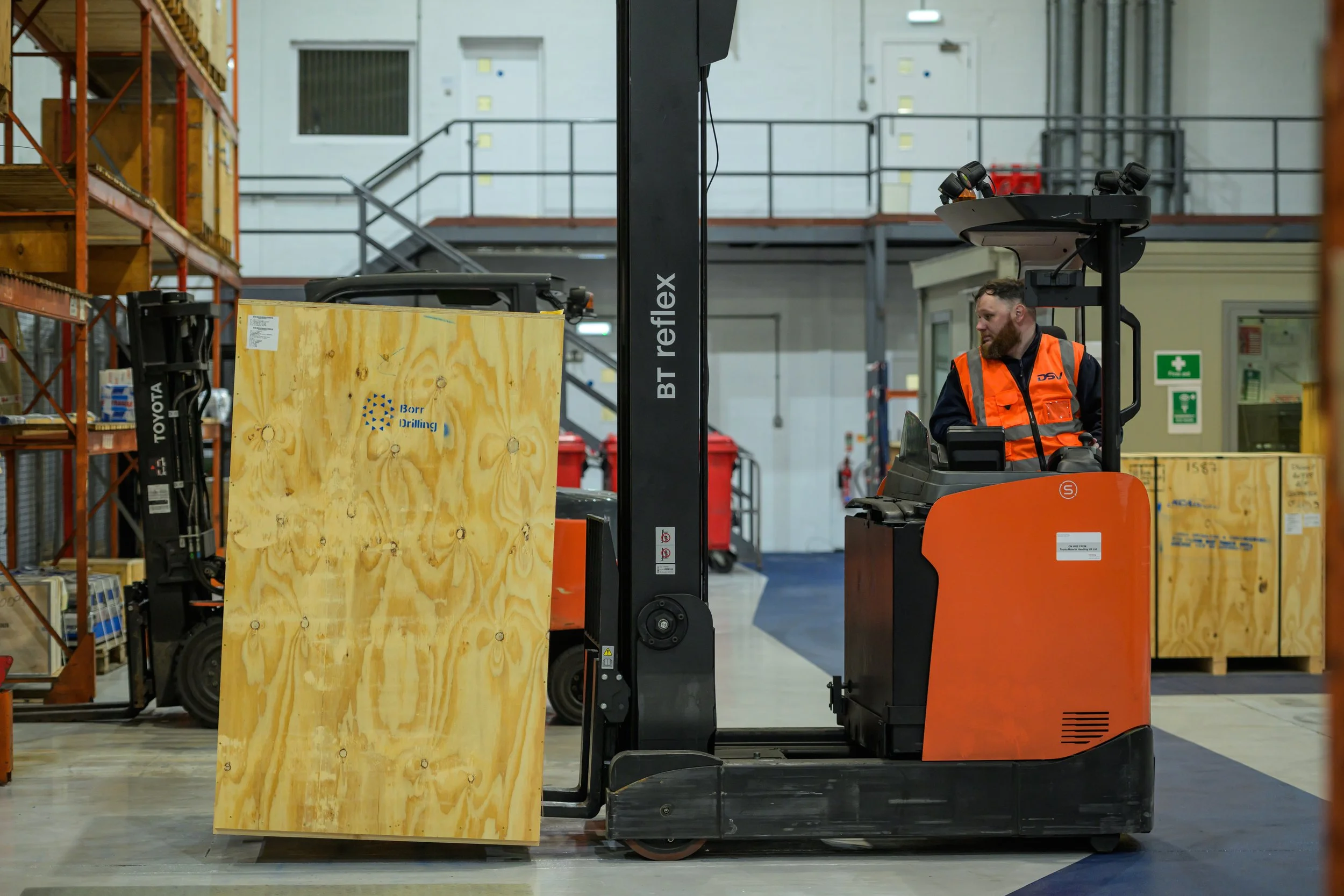 Forklift driver moving a large crate inside the DSV Aberdeen warehouse.