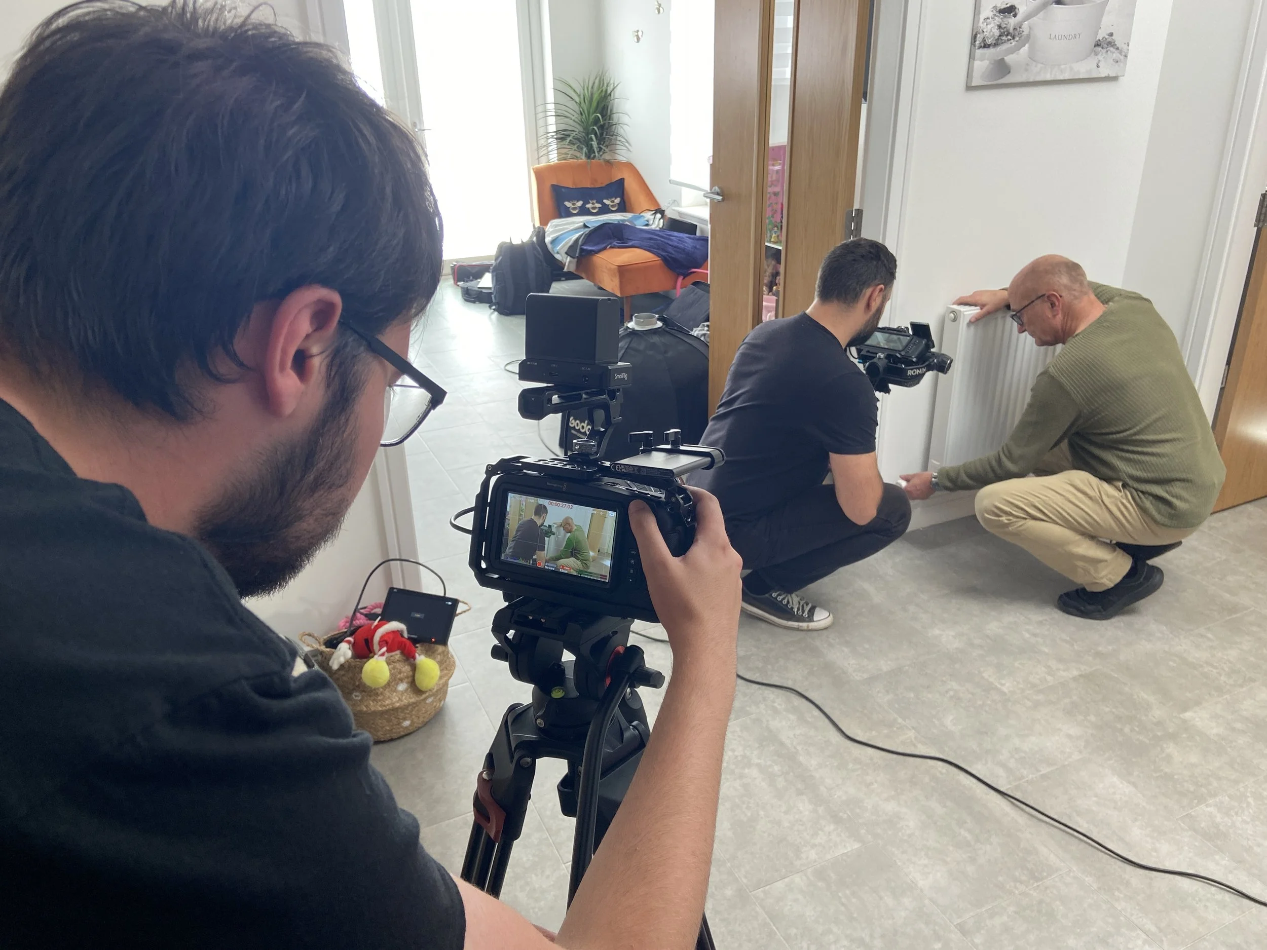 Farsight crew filming an actor beside a radiator for the John Mutch Building Services brand film.