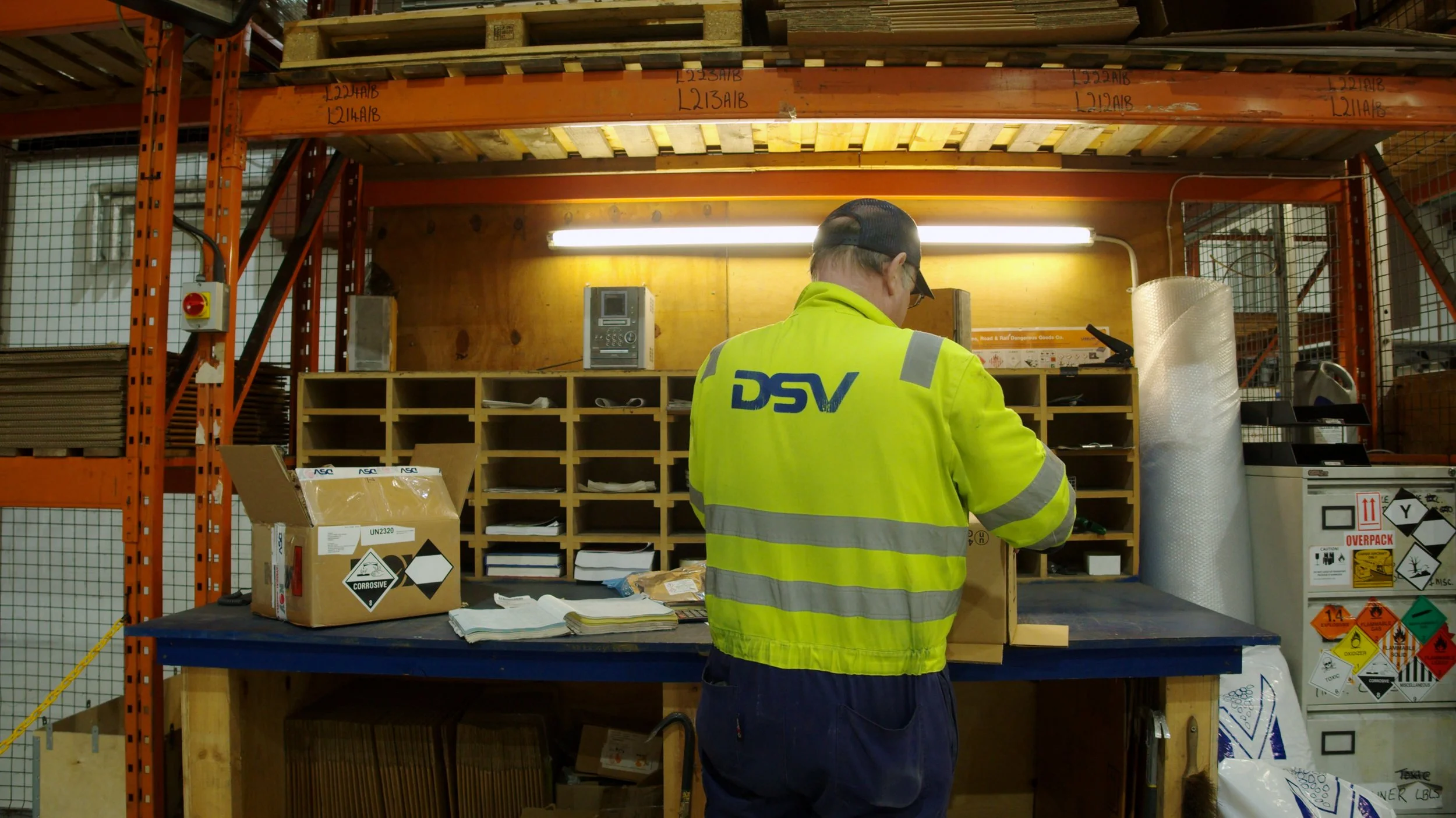 DSV Aberdeen employee working at a computer workstation, photographed from behind.