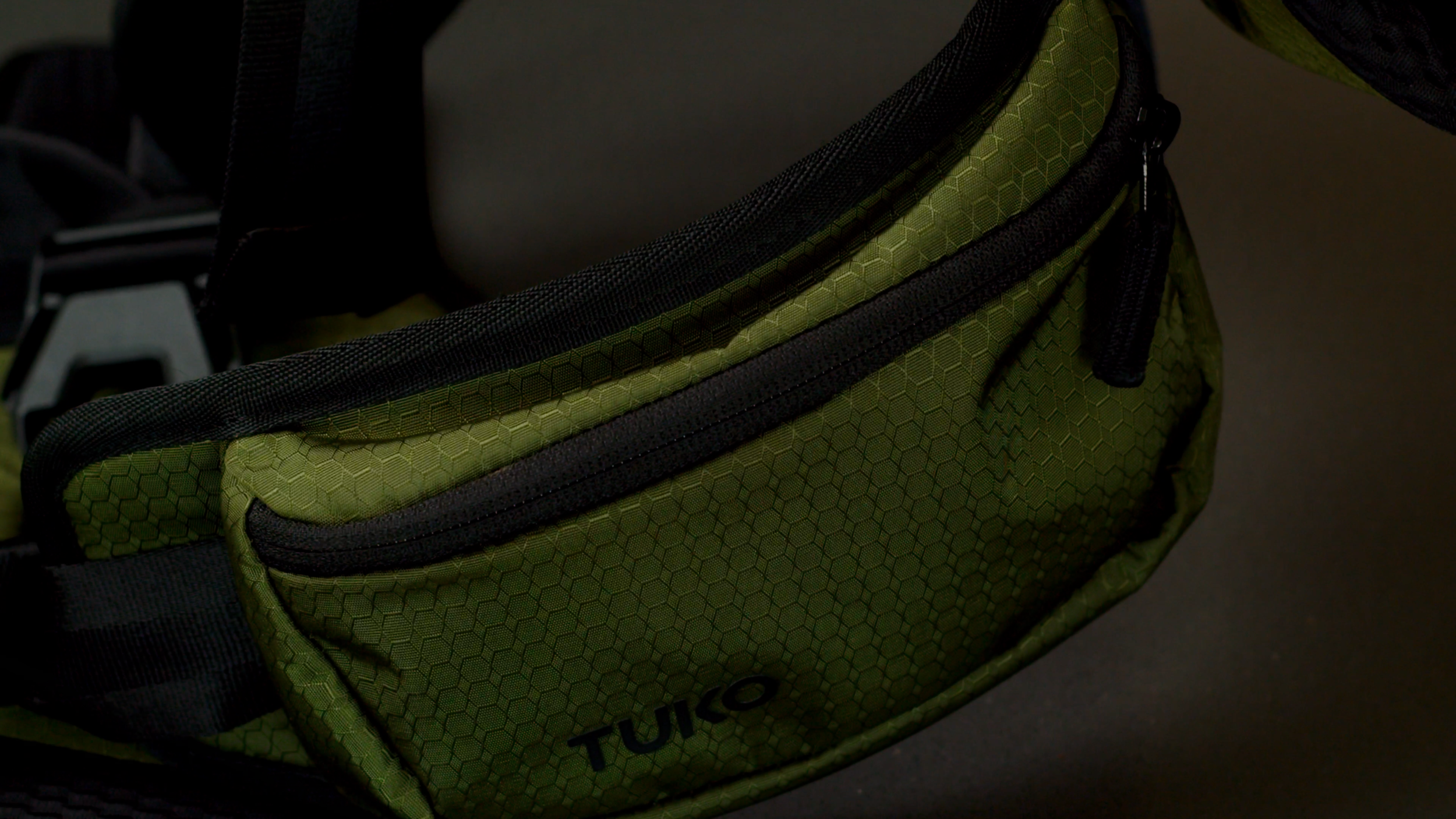 Close-up of the zipped storage bag on the TUKO baby carrier.