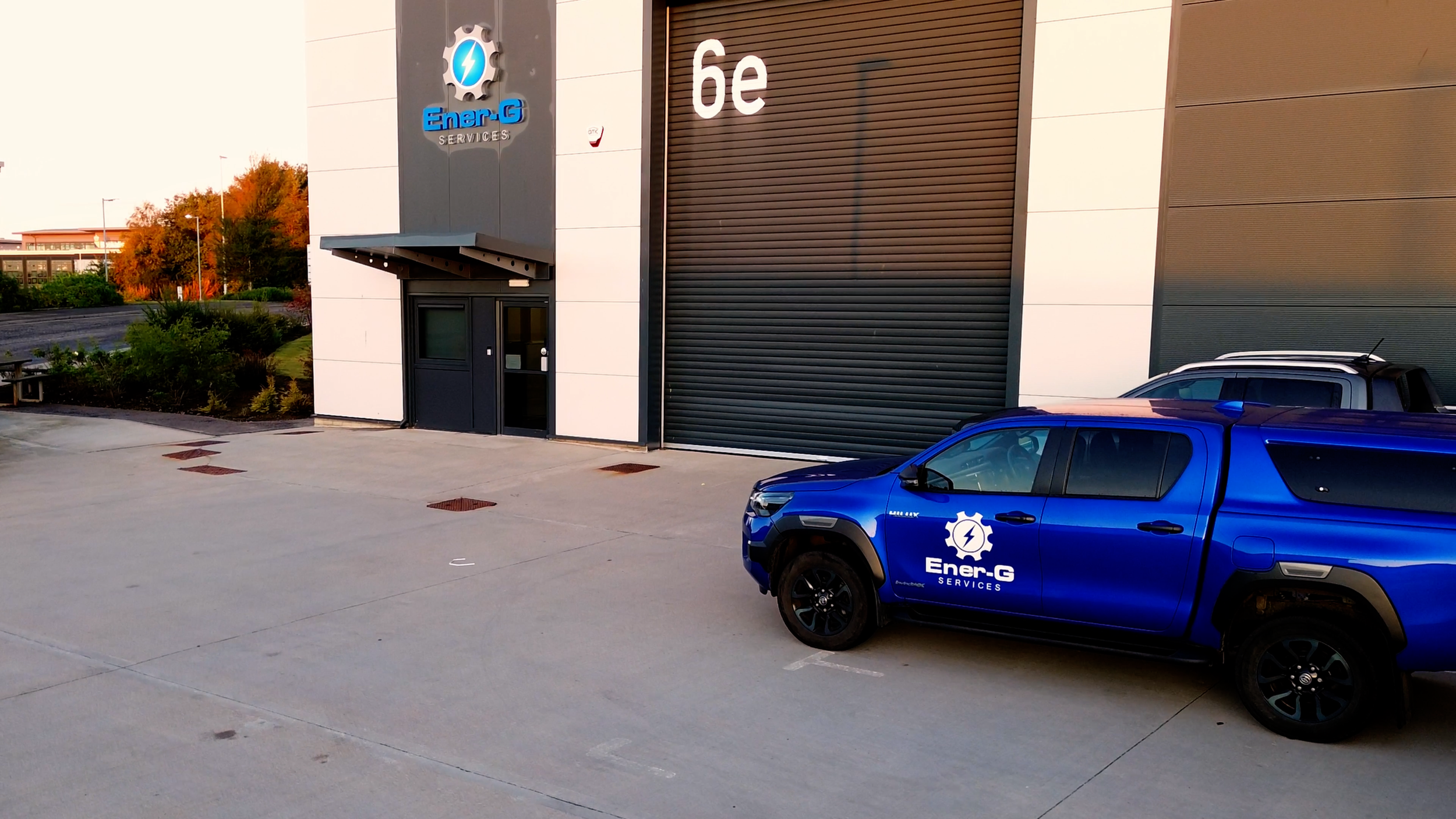 Ener-G Services office building with a branded company vehicle parked outside.