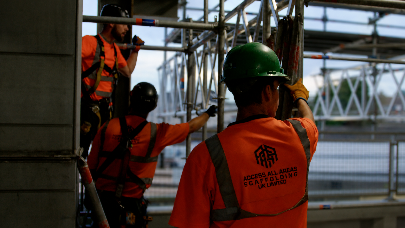 Three AAA Scaffolding team members carrying out work together on site.