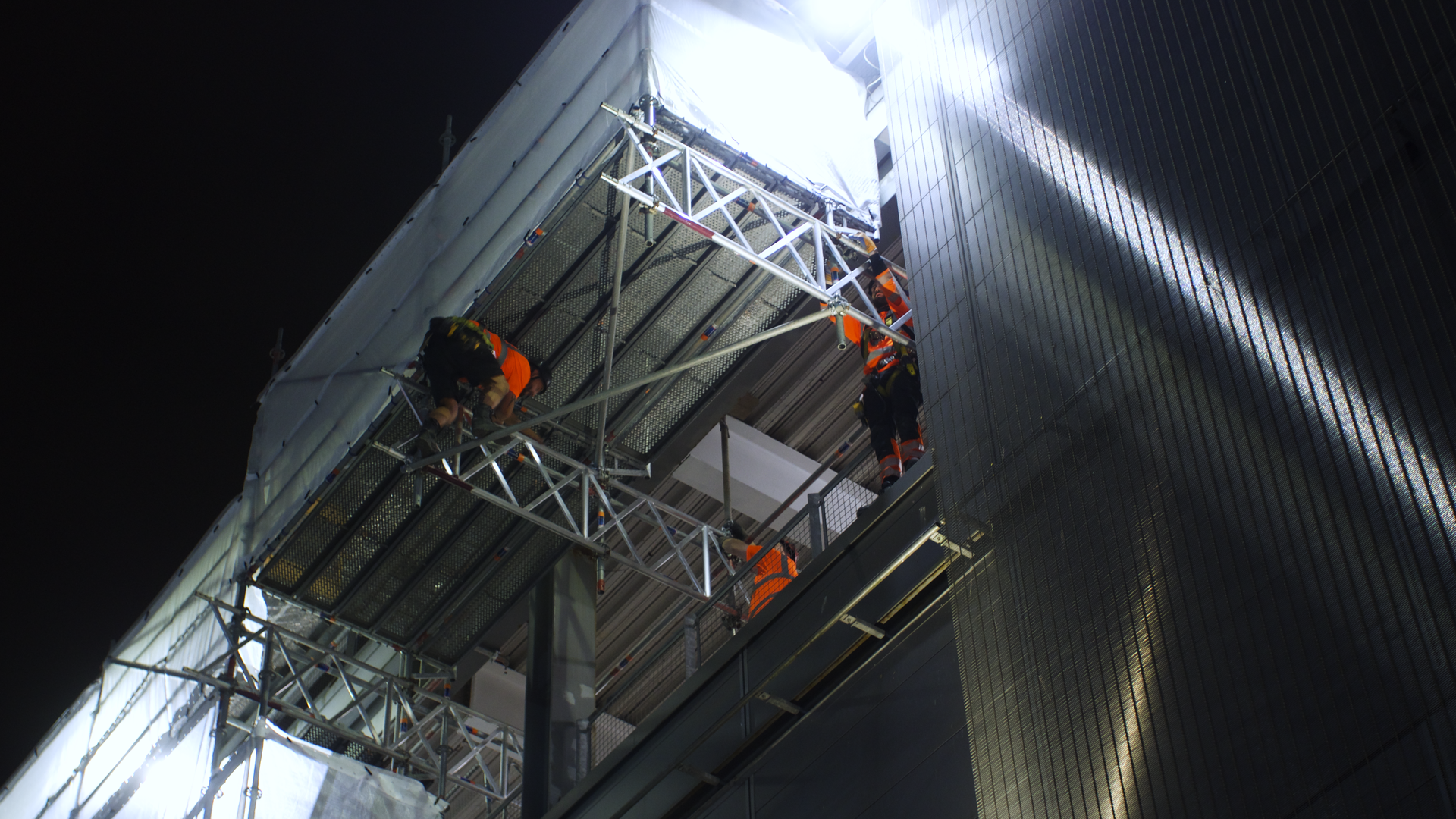 AAA Scaffolding team members working at height from a scaffold platform.