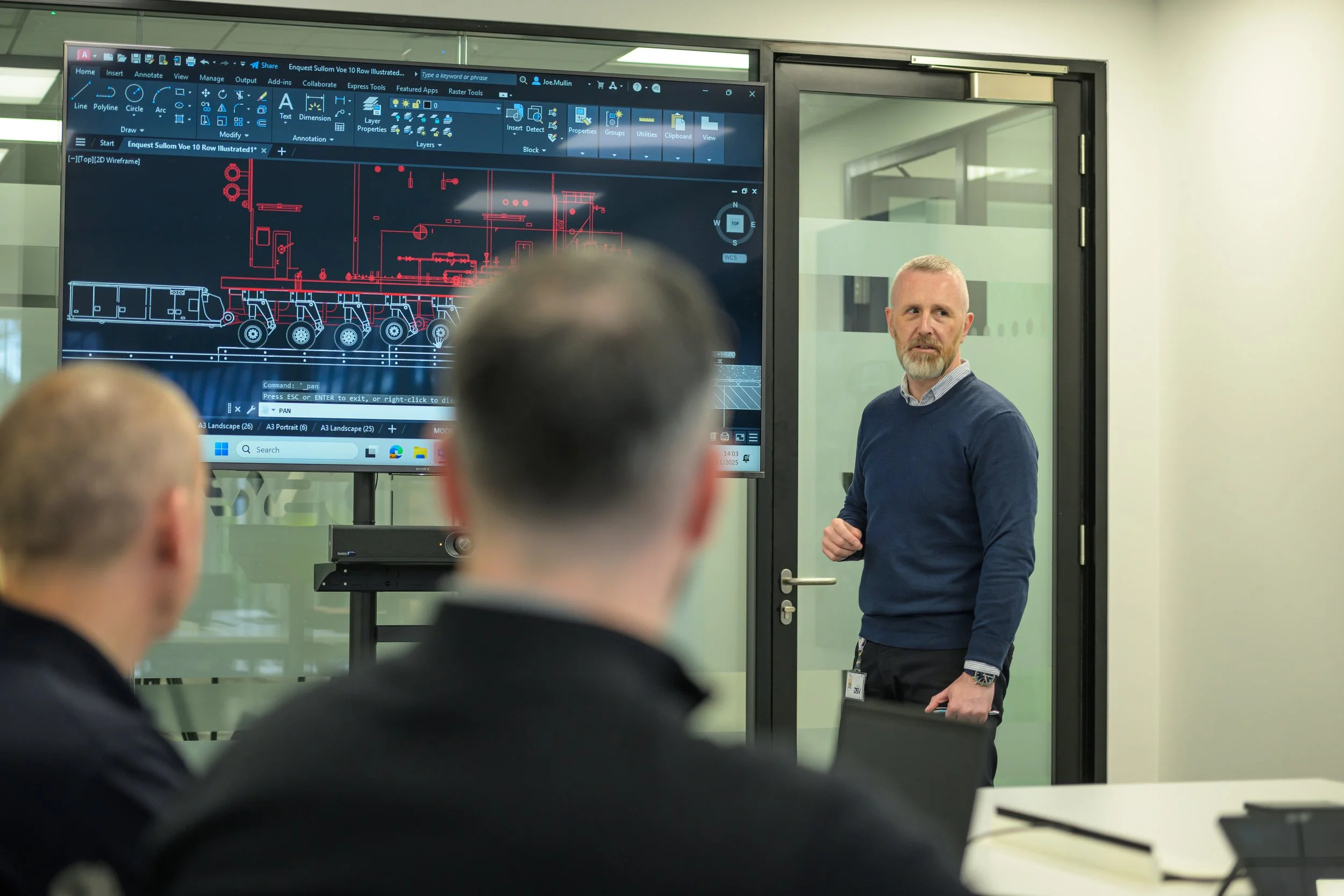 DSV Aberdeen team members discussing a diagram displayed on screen during a strategy session.