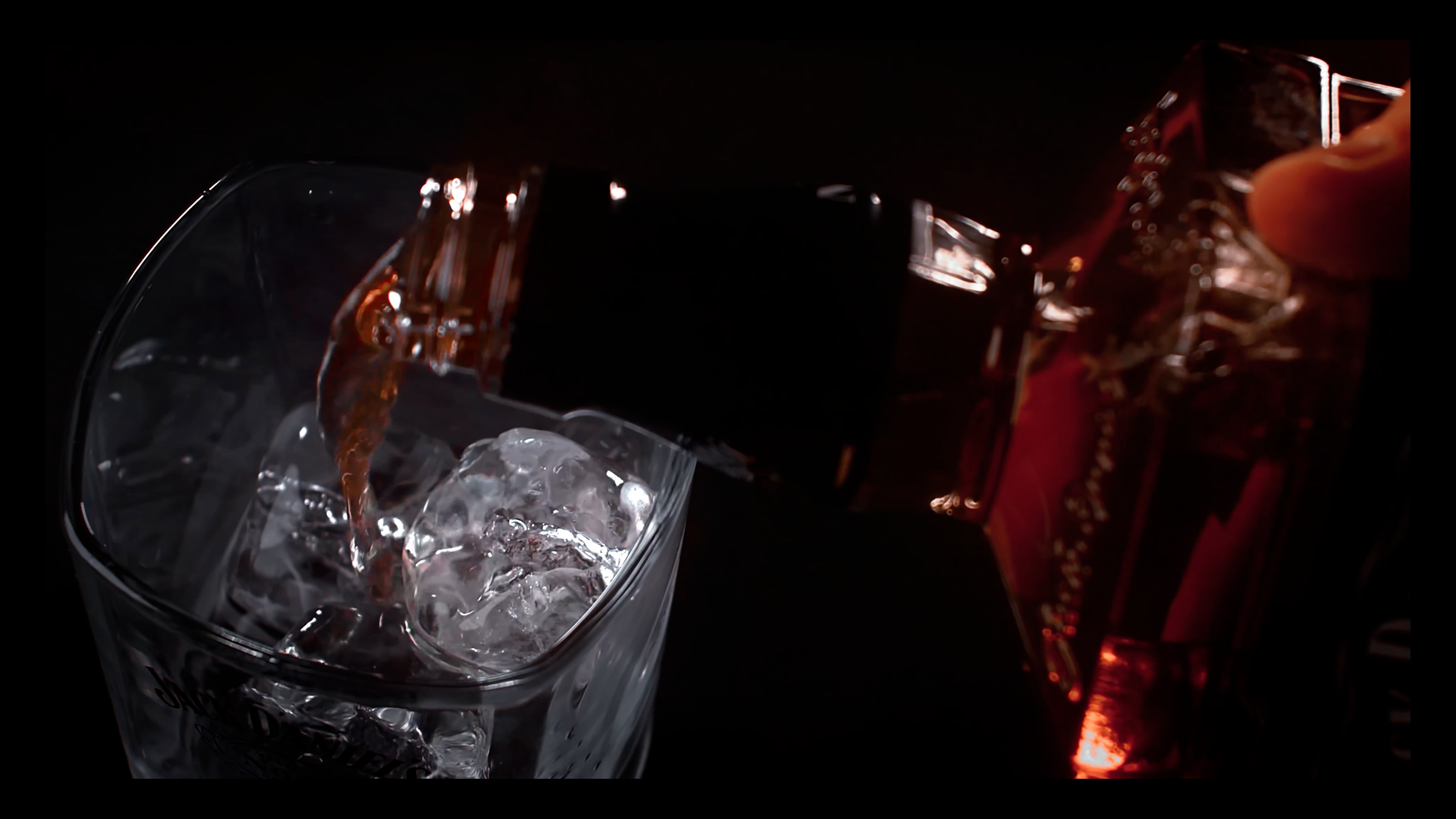 Bourbon being poured from a Jack Daniel’s bottle into a glass during Farsight’s independent spec film.