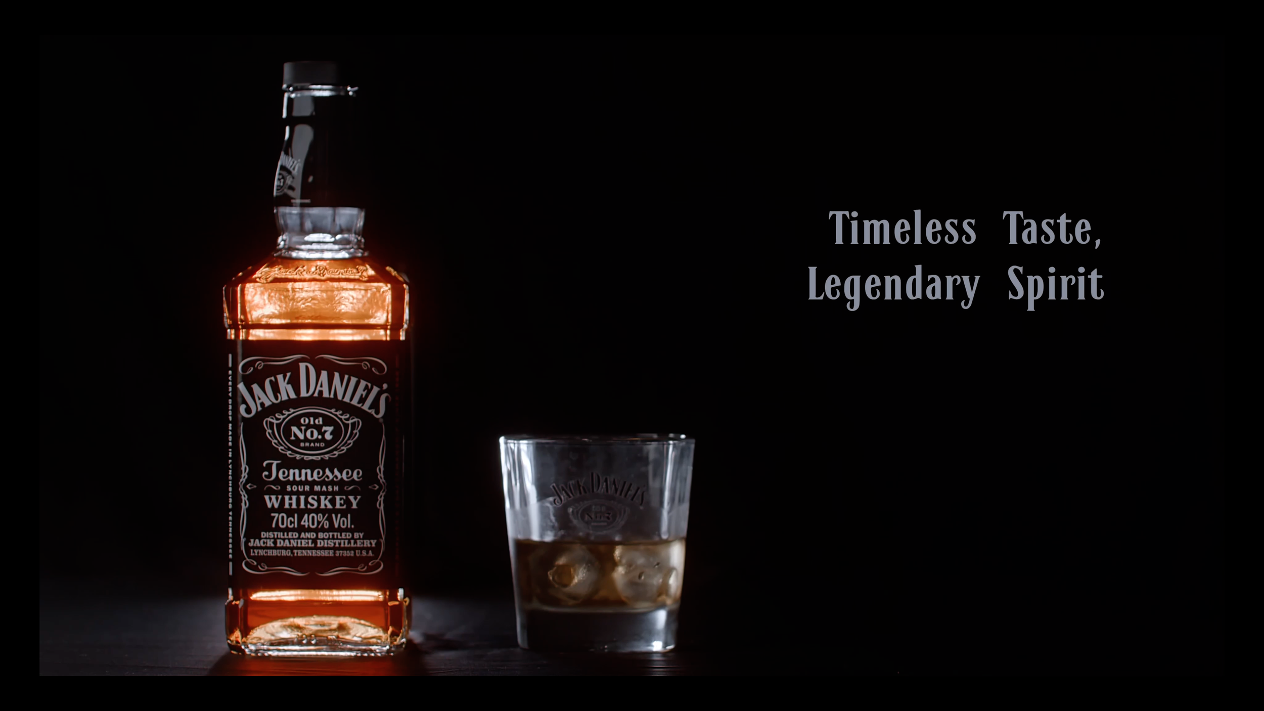 Jack Daniel’s bottle beside a glass of bourbon and ice with the words Timeless Taste, Legendary Spirit.