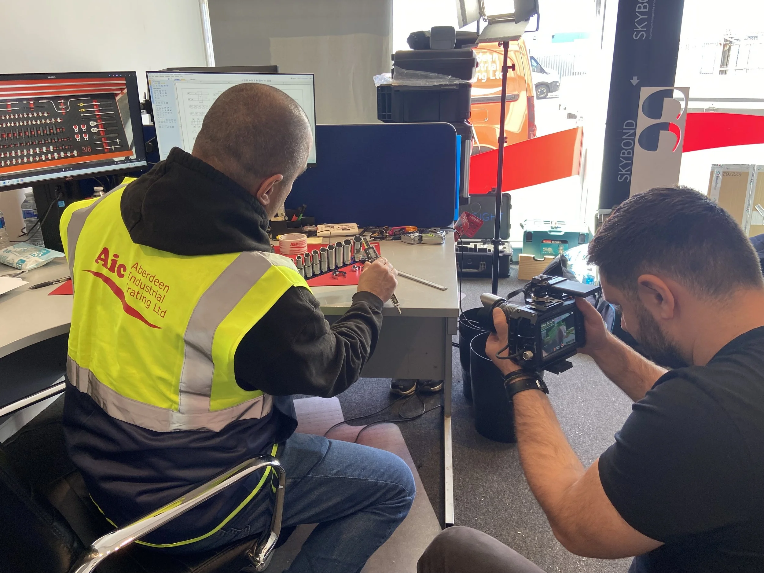 Farsight crew member filming an AIC employee measuring tools for a custom protective case.