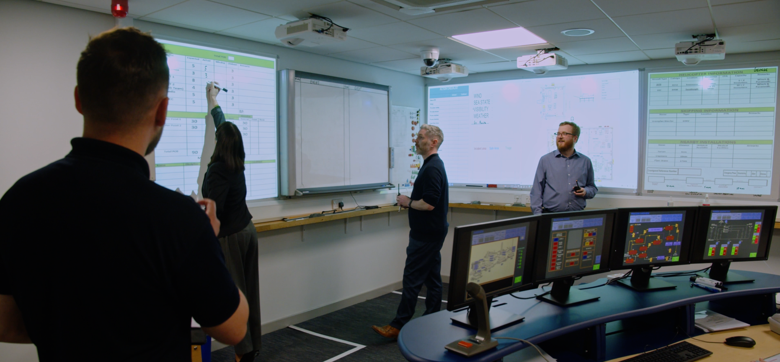 Participants writing on a board during a safety training session at ASET.