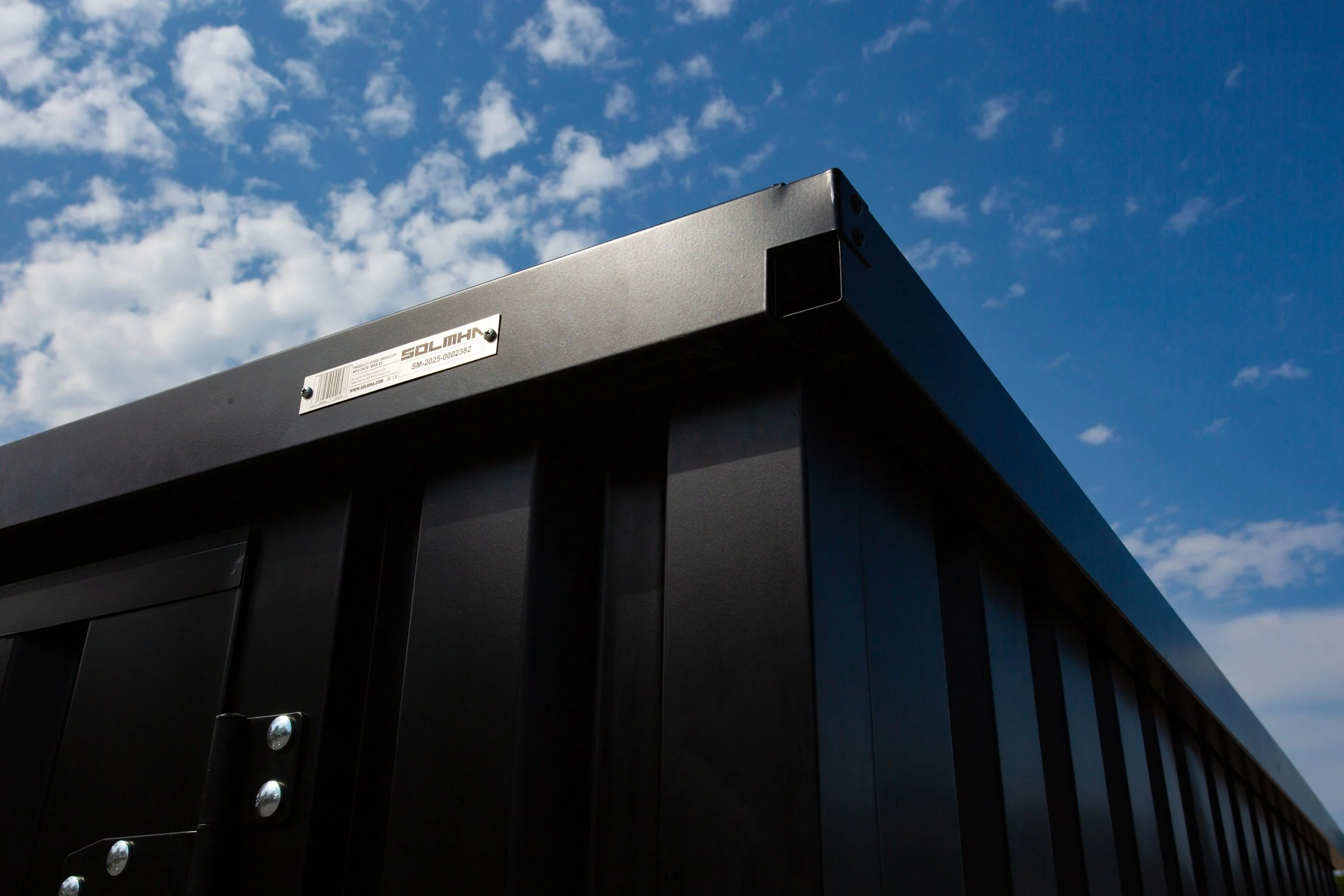 Close-up of the Site Store container corner and branded steel plate.