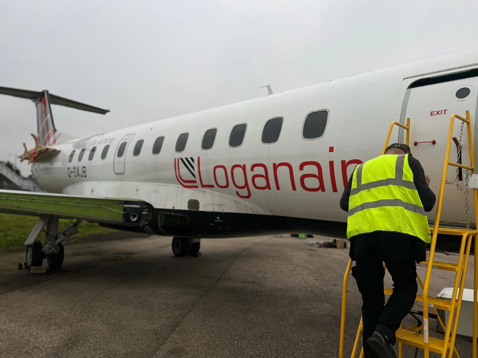Person walking up the steps towards the aircraft entrance during the CMD Group Scotland project.