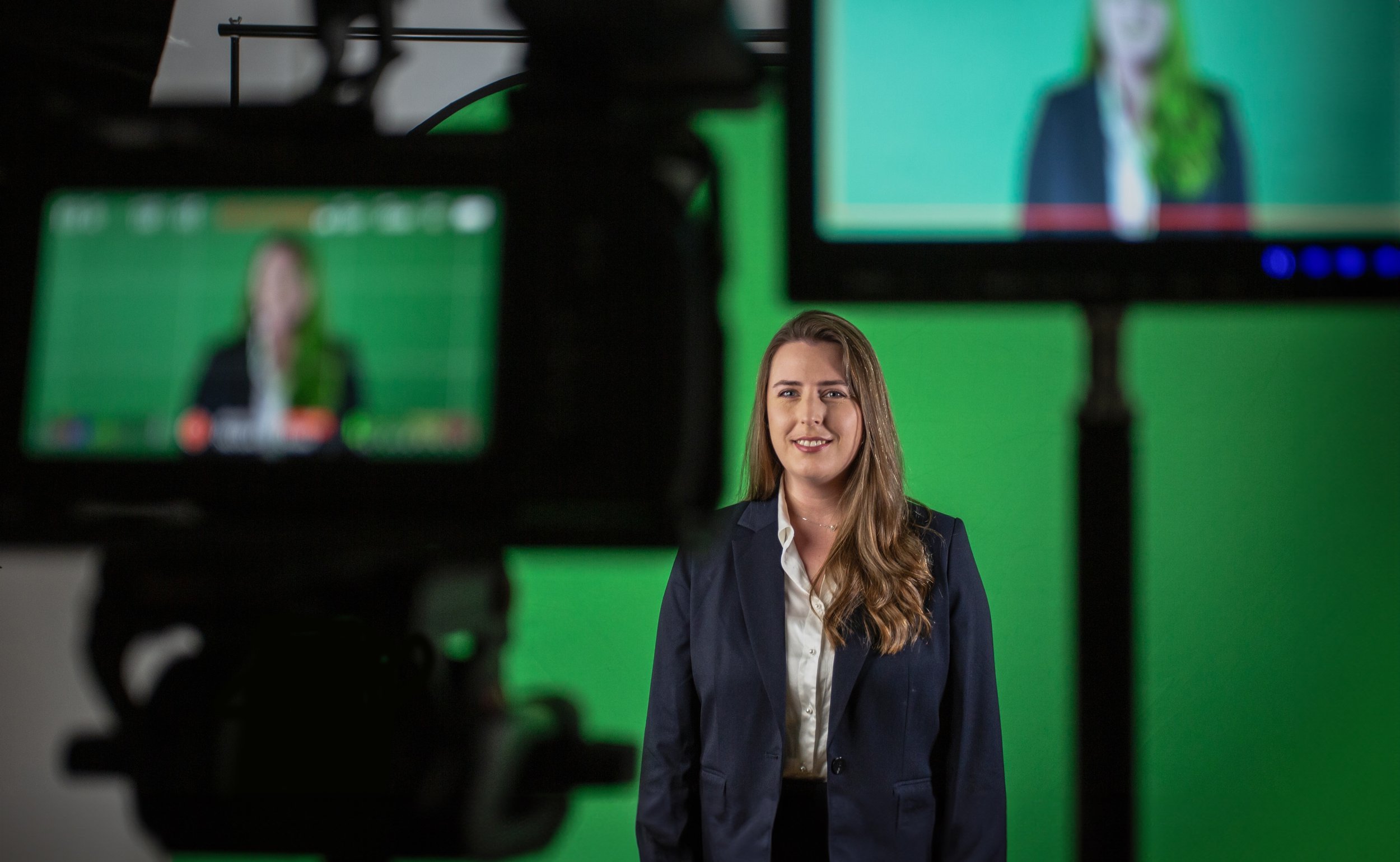 An on-camera presenter recording against a green screen during a Farsight production.