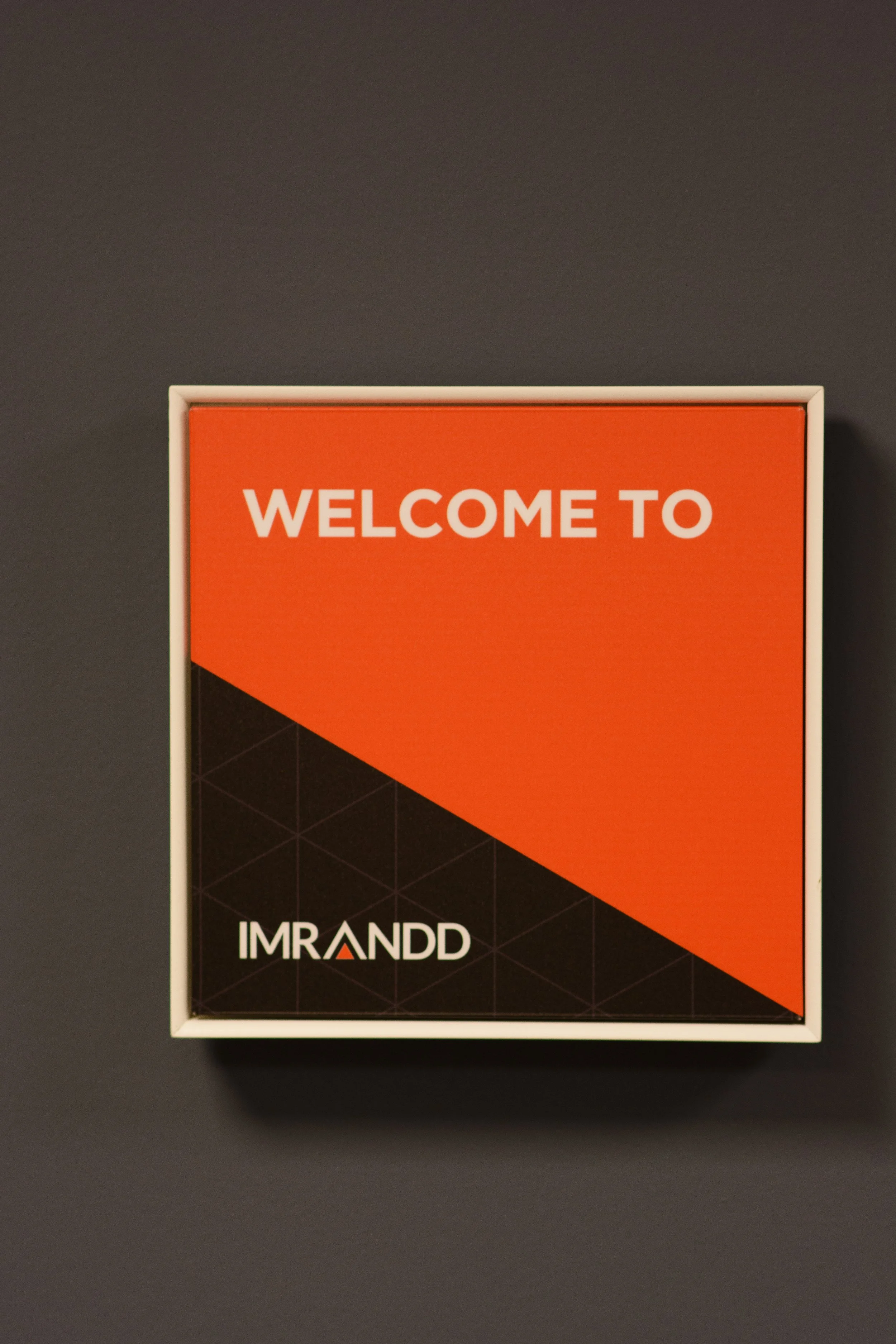 Welcome to IMRANDD sign displayed on an office wall.
