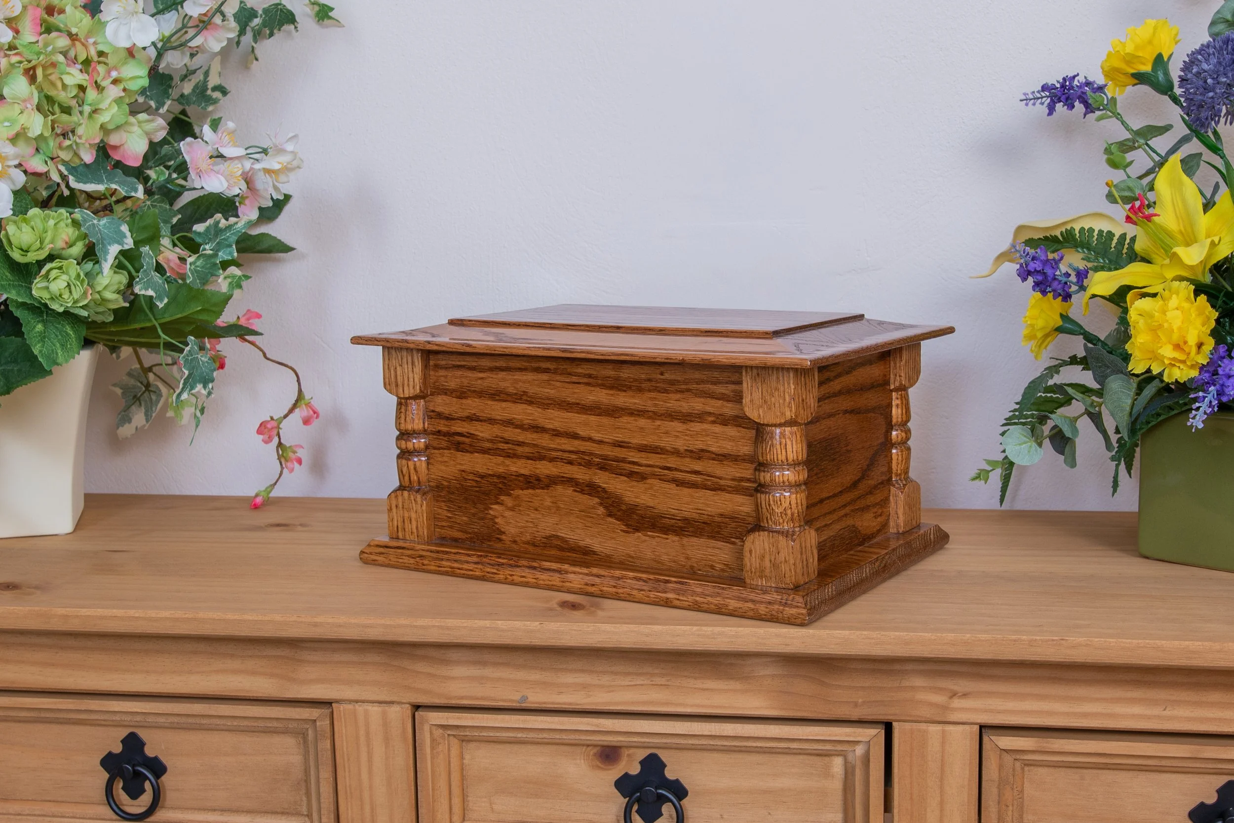 Ash casket in medium oak veneer.