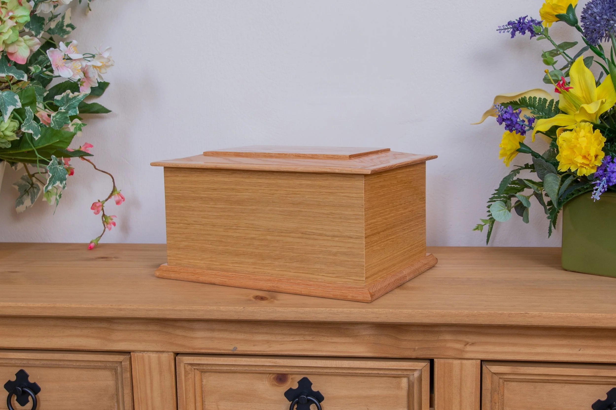 Ash casket in light oak veneer.