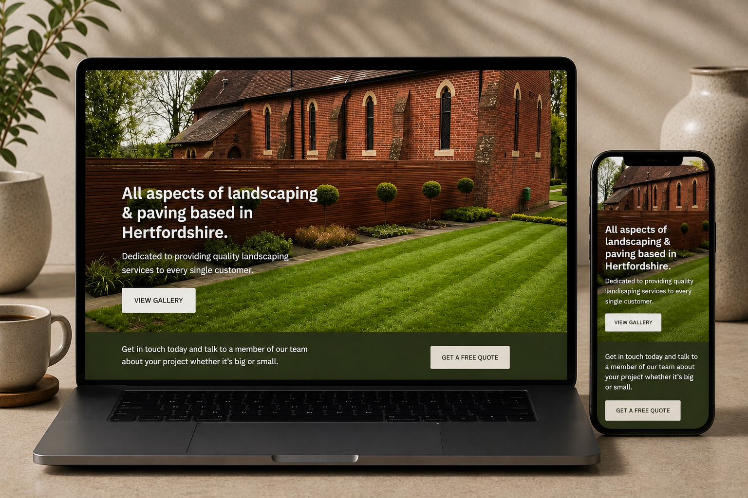Website displaying landscape and paving services with a large brick building, a wooden fence, a neatly maintained lawn, and trees in the background.