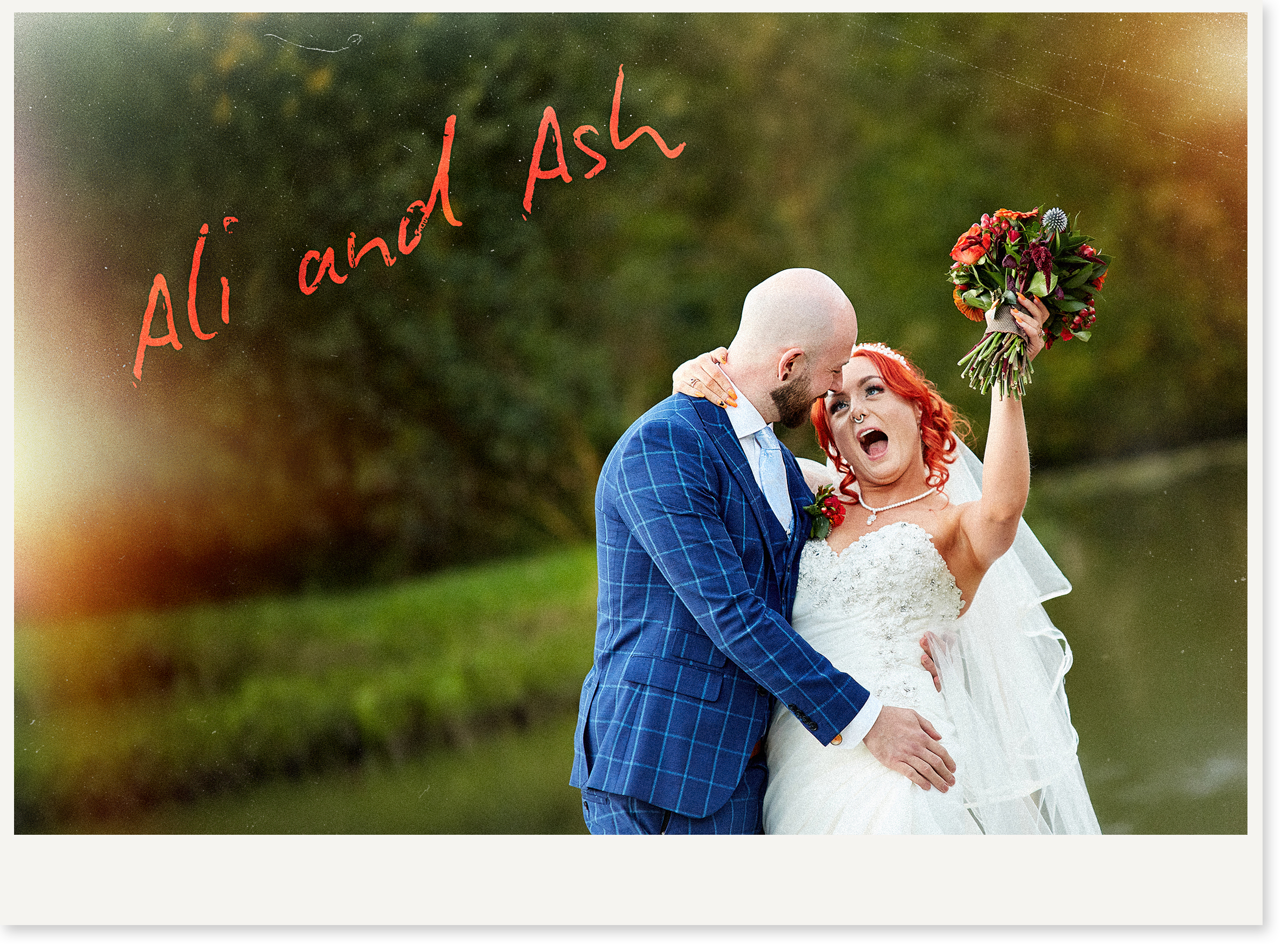 A couple celebrating their wedding outdoors. The woman with red hair is holding a bouquet of flowers and is speaking excitedly, while the man with a bald head and beard is dressed in a blue checkered suit and is smiling. The background features greenery and the words 'Almost and' written in red.