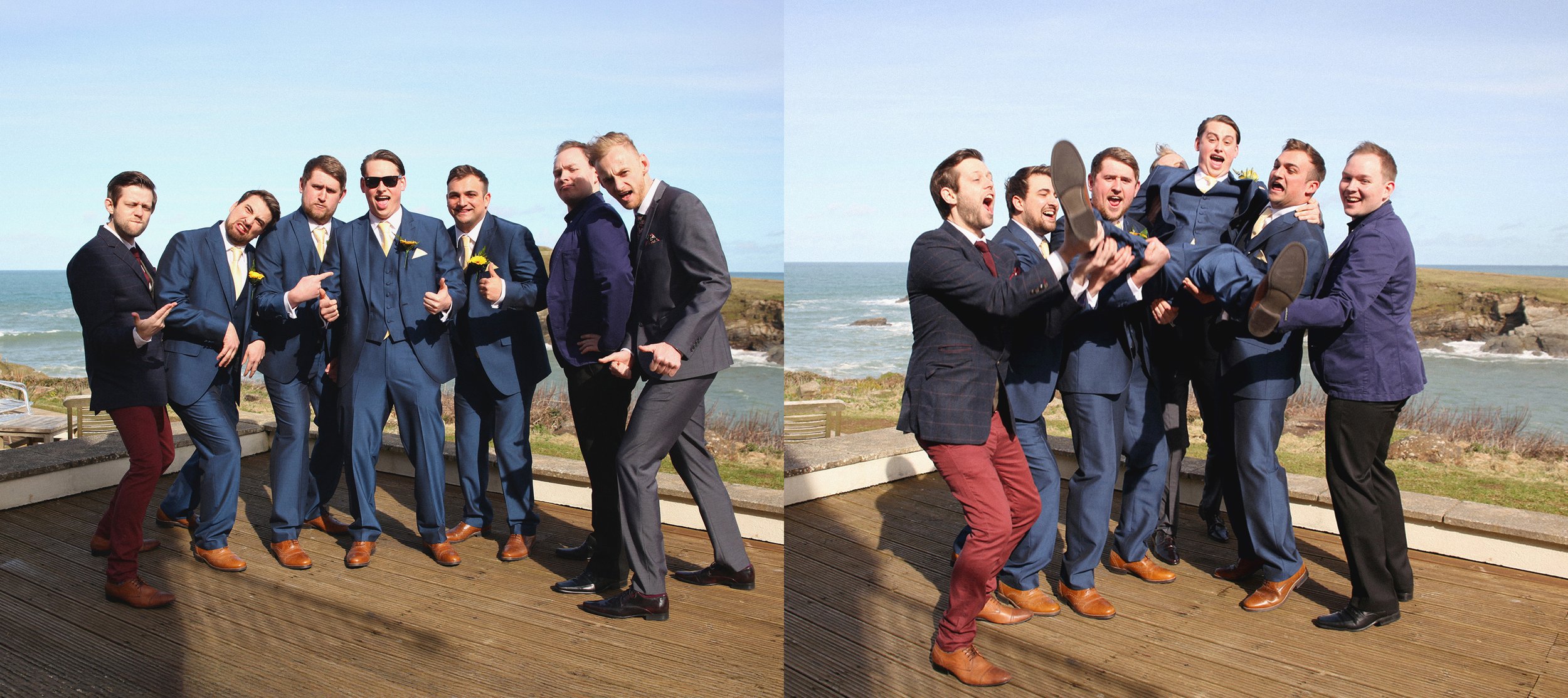 Group of men in suits at a coastal outdoor setting, some posing and others lifting a man in a suit, with ocean and sky in the background.