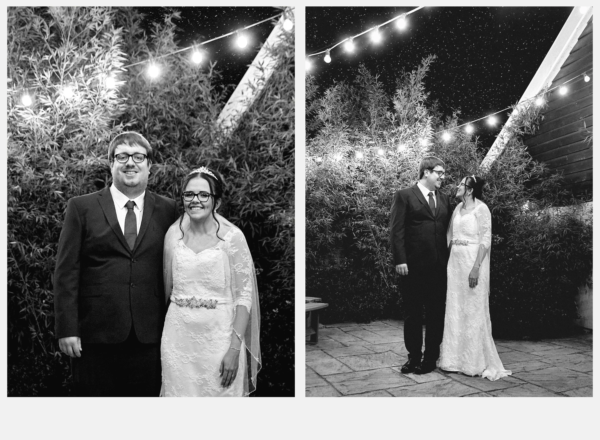 A black-and-white photo of a couple at night, dressed in wedding attire, standing outdoors under string lights, with trees and a building in the background.