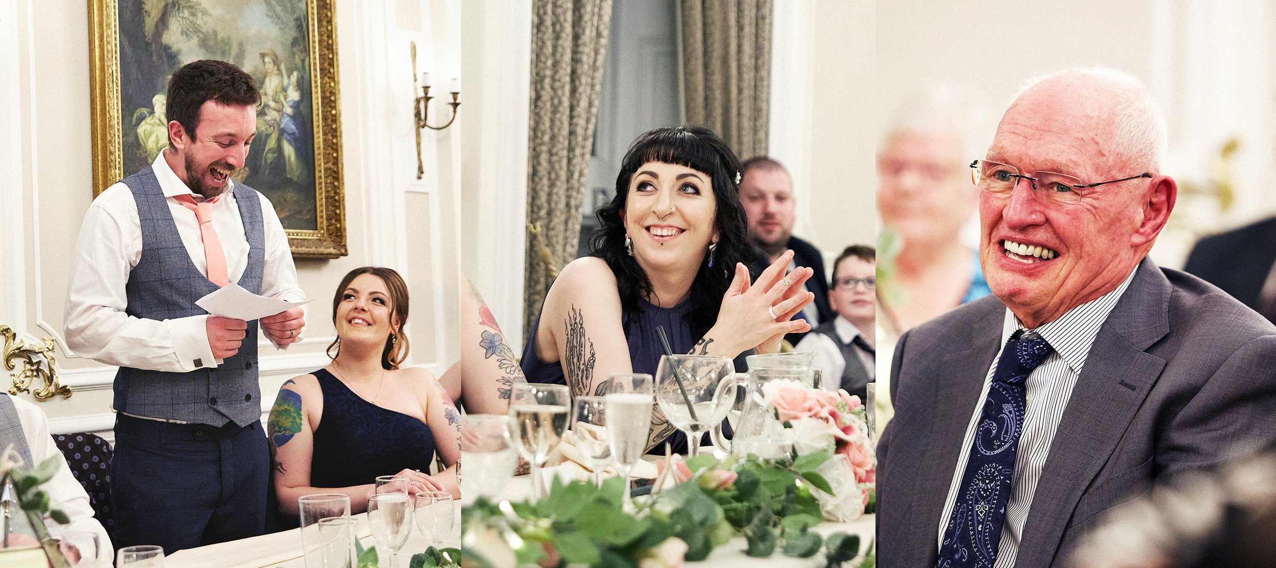 A group of people at a formal event, with a man giving a speech or toast, a woman smiling, and an older man laughing, surrounded by glasses and floral decorations.