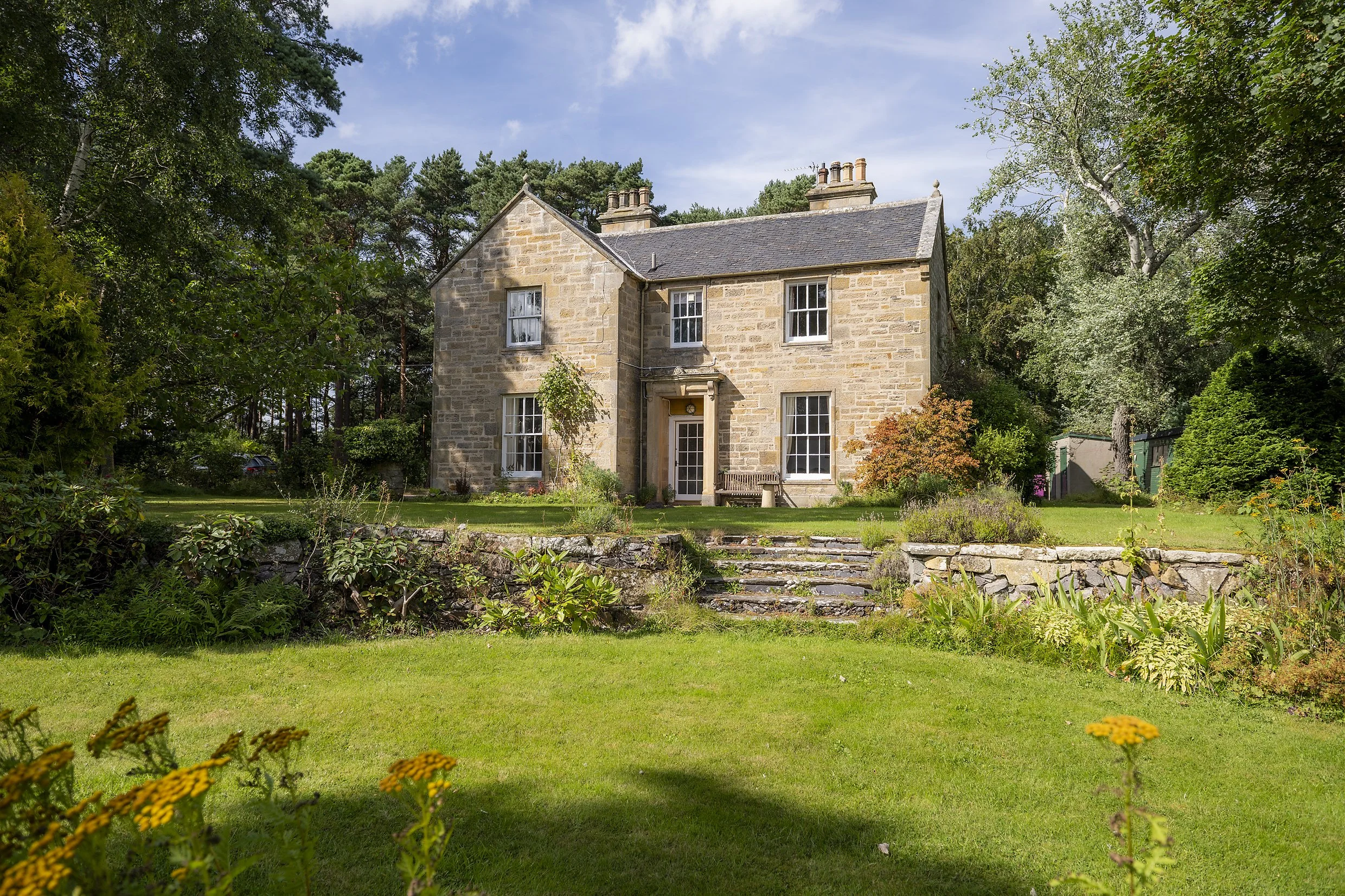 Cullerne House surrounded by gardens and woodland in Findhorn