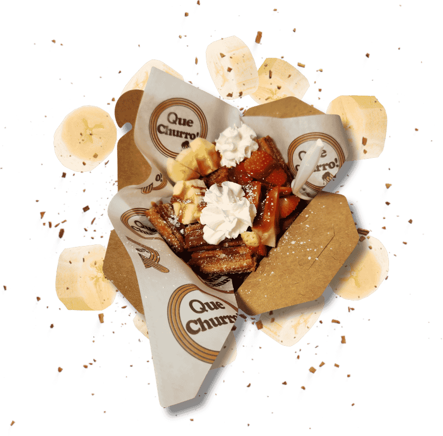 A loaded Que Churro dessert box topped with whipped cream and fresh fruit, perfect for sharing.