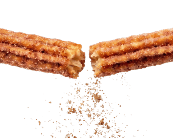 Que Churro Churro Chopped cinnamon-sugar churros with sugar granules falling in mid-air in San Benito, Texas