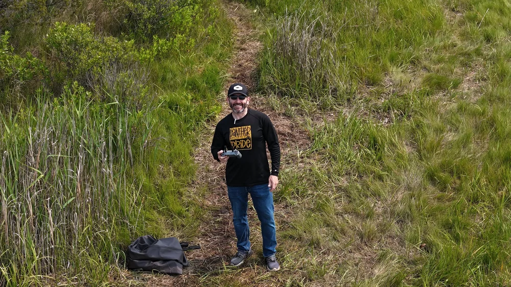 William Pirl outdoors holding a drone controller
