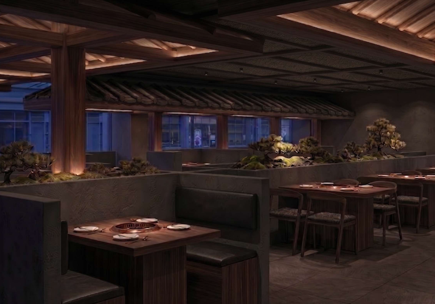 Interior of a modern Asian restaurant with wooden décor, low lighting, and tables set for dining, including grill stations built into the tables.