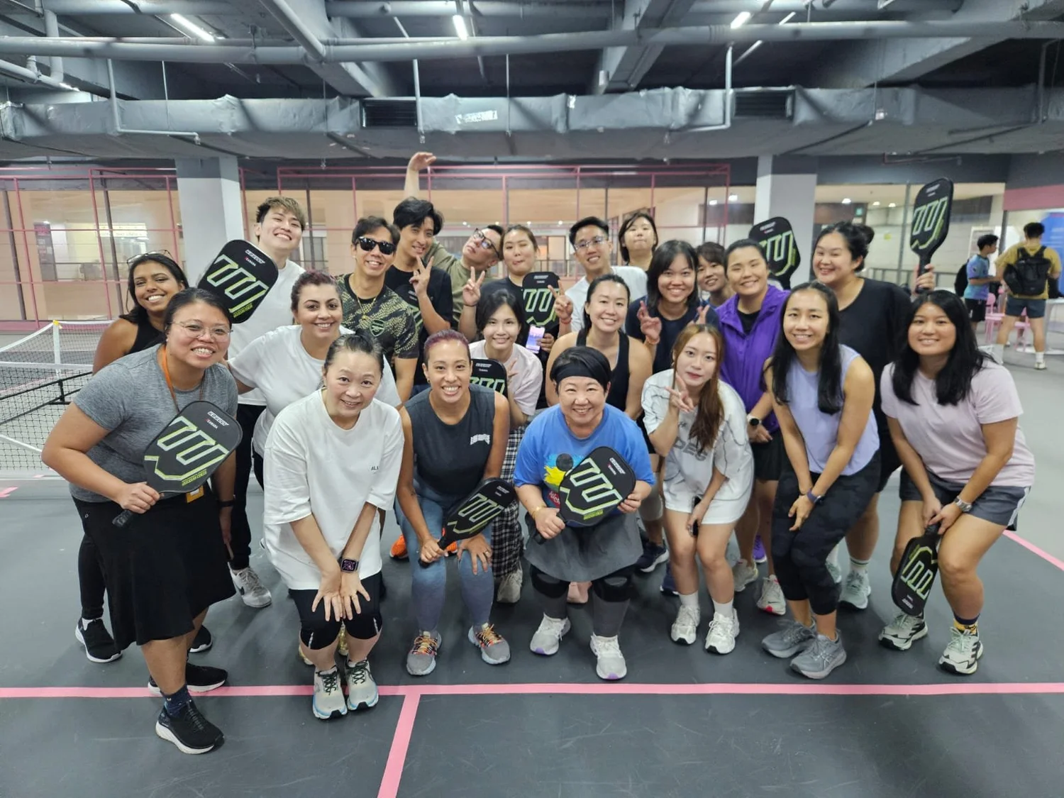 Corporate team after an indoor pickleball team-building workshop