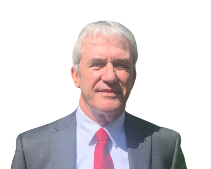 A middle-aged man with gray hair wearing a gray suit, white shirt, and red tie.