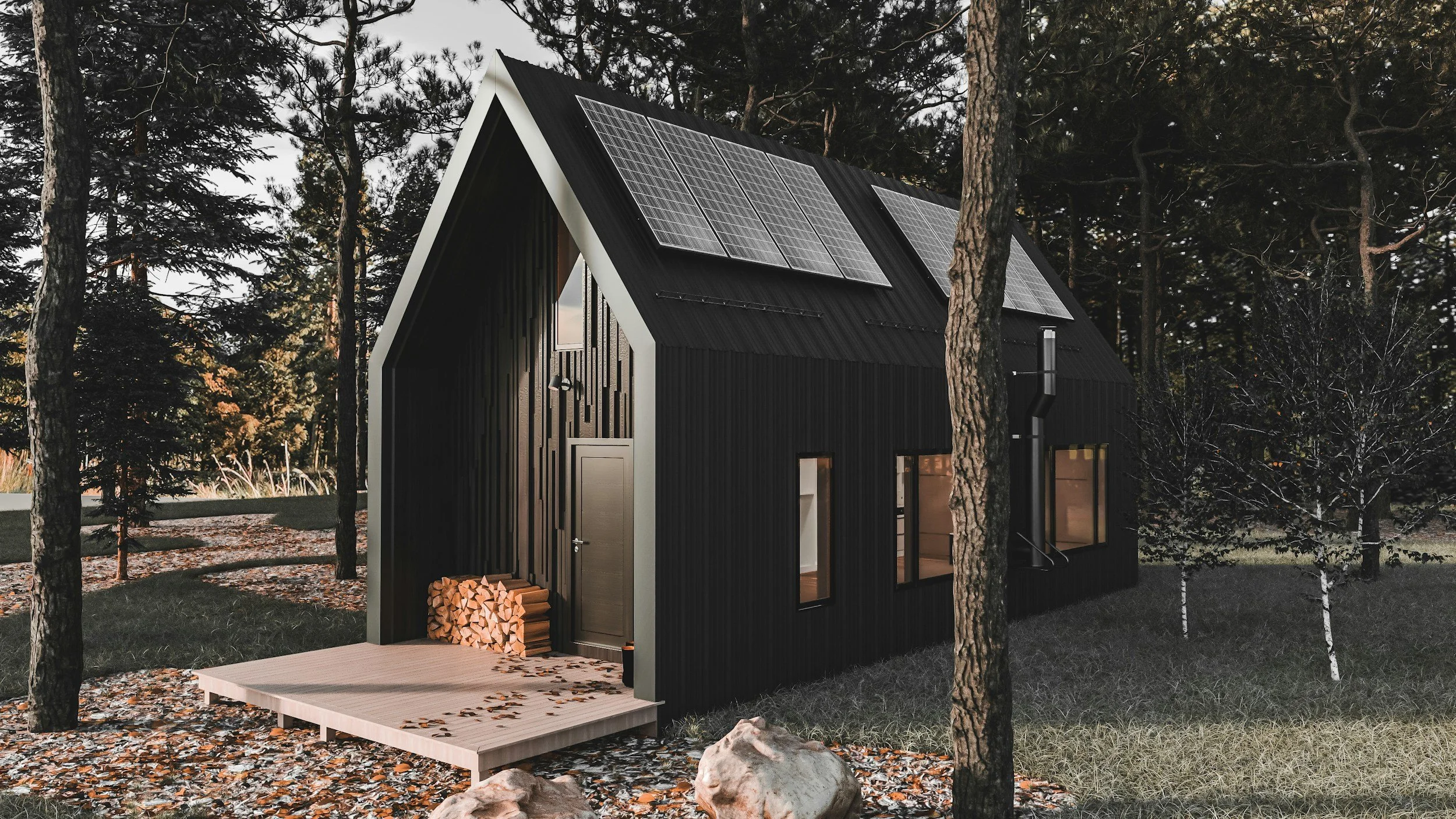 A black modern house with solar panels on the roof, situated in a wooded area with trees and fallen leaves, featuring a small porch and woodpile.