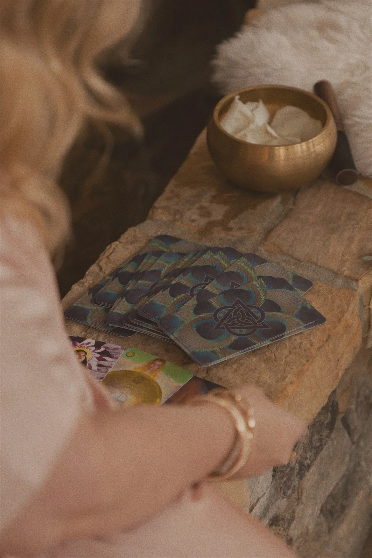 Danielle Hendrickson holding oracle cards at a wooden altar with crystals, preparing for a 13 Moon Oracle Reading