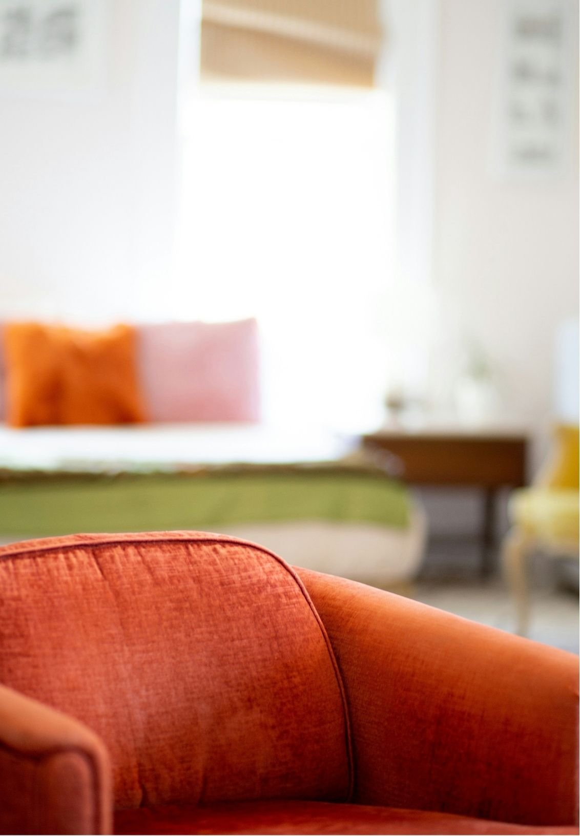Orange upholstered armchair in a bright modern living room